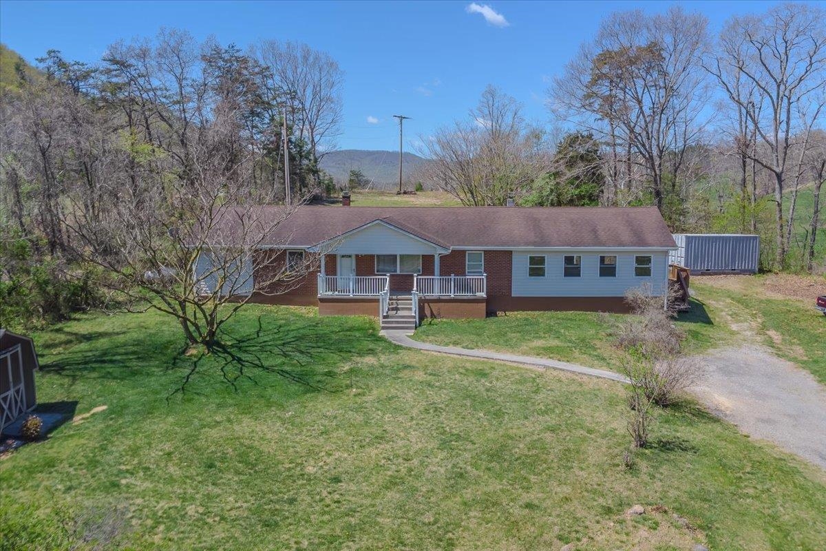 Discover the potential of this unique 7.2-acre property, ideally located just off the interstate with easy access to Virginia Tech & Roanoke! A former small farm, this private retreat offers multiple opportunities for investment, residential, & possible commercial use. The main brick home features unfinished square footage, perfect for adding quick value. A whole-house generator, outdoor wood furnace, & hardwood floors add to its appeal. A second brick home also sits on the property, providing excellent rental income potential. The land is mostly fenced, with a tool shed/outdoor storage & a parcel bordering the North Fork Roanoke River. Positioned at the foot of the Fort Lewis Mountain range, this property is ideal for those seeking privacy & versatility. For those considering commercial ventures, the location offers strong potential for storage units, parking, or a truck repair facility. Don't miss this rare opportunity to own a multi-use property in a prime location!