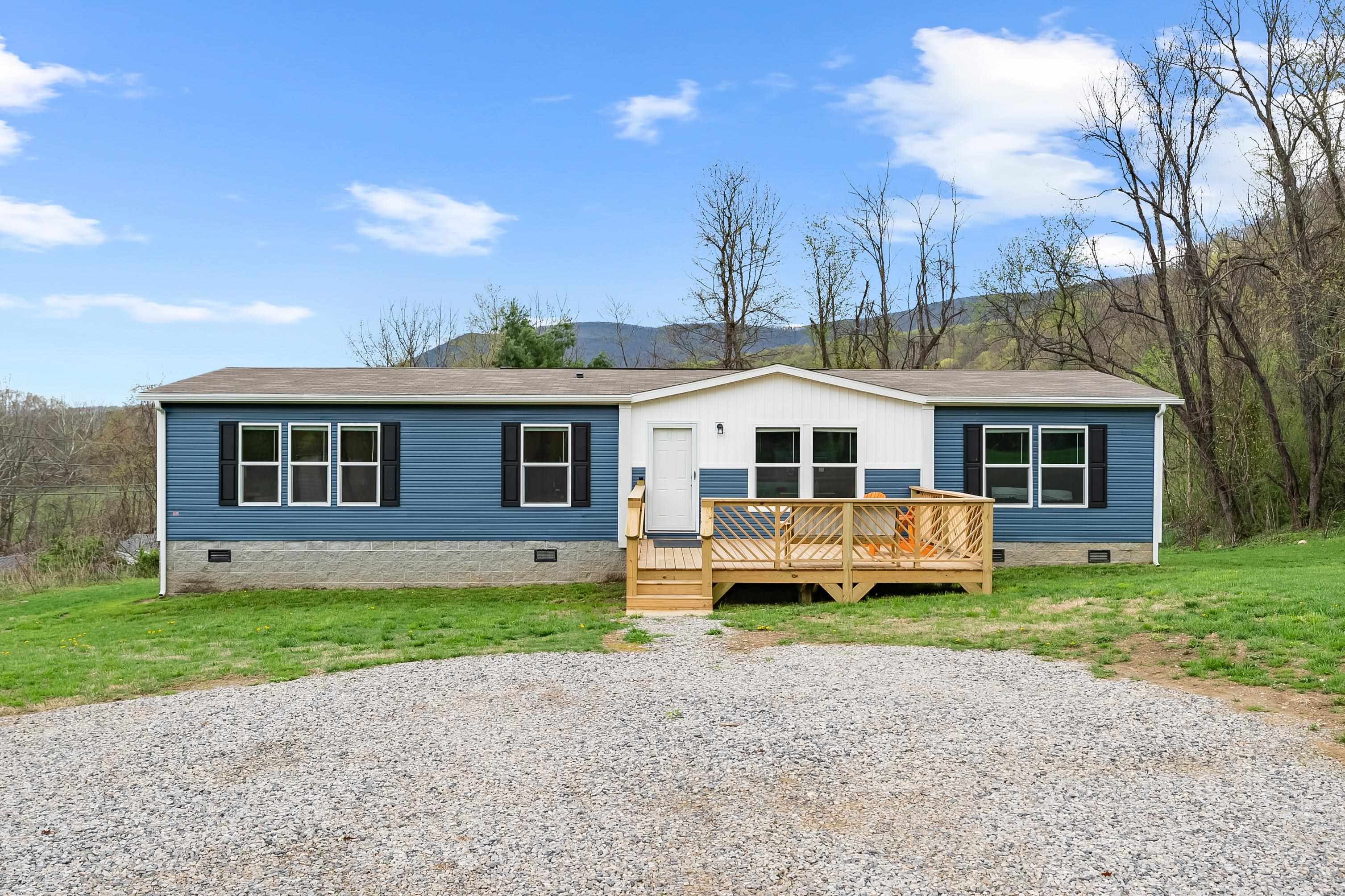 Check out this brand NEW, 3 bedroom/2 bathroom doublewide situated on a little over 1 acre. With over 1,700 sq. ft., this spacious home will provide plenty of room for you and your family. Located less than 10 mins to downtown, restaurants, shops, boat ramp and more. Come take in the mountain views that this property has to offer. Enter from the front deck to the living room with lots of natural light. There you will find the open layout to the kitchen that boasts a kitchen island w/ bar seating, LVP flooring, black appliances and beautiful cabinets. The primary suite, with a walk-in closet, is located on the right side of the home giving privacy from the other 2 bedrooms on the left side. The primary bath has a soaker tub, walk-in shower, dual sink and vanity. There is also a formal dining room and family room in the home. Again, everything in this home is NEW! What more could you ask for. Schedule your showing today!