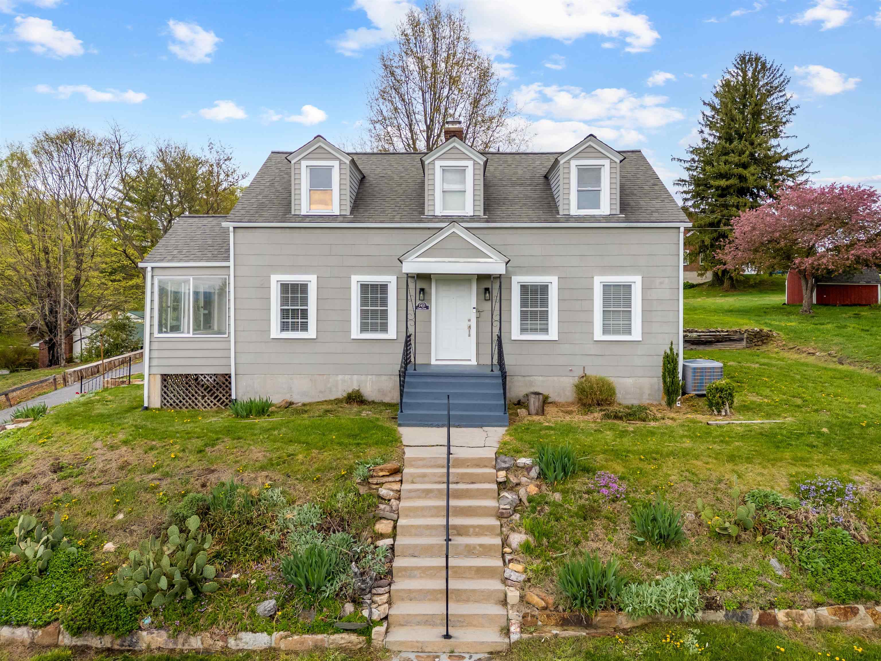 This charming cape cod home has 3 bedrooms and 2 baths. It is located in a desirable neighborhood that is conveniently located to shopping and schools. This property hosts hardwood floors, arch doorways, custom molding and beautiful views.  Bathrooms have been recently updated, and the primary bedroom is on the main floor.  The laundry area is also on the main level and comes complete with a washer and dryer that convey.  There is also a sunroom that leads to the deck which has new deck flooring. There is a full basement for plenty of storage and an outdoor shed for your mower.  This property has much to offer.  Schedule your showing today.