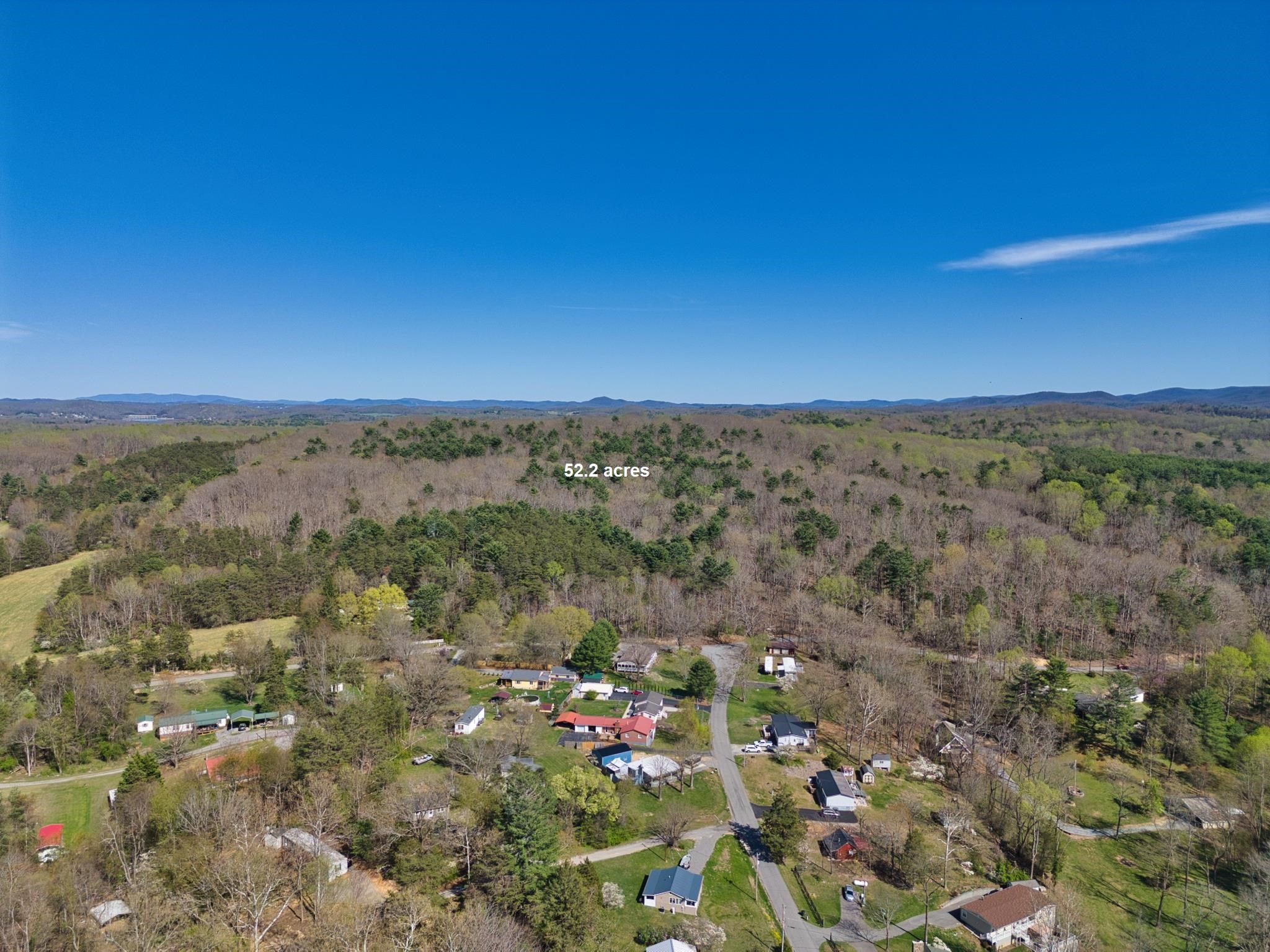52+ Wooded acres to cut out trails for ATVs, or hiking to enjoy nature and the peaceful surroundings.  Find that perfect spot to build your dream home or cabin. A possible trail does run from Owens Rd to Woods on The Lake with some clearing.  DeHaven Park is just across the Owens Rd frontage on Beach Dr.  A recreational park with swimming, fishing, picnicking, and boat launch. The property is zoned low residential density if you have more expansive plans. 529.4 feet of frontage on Owens Rd, 153.12 of frontage on Woods on the Lake. Several great spots for a cabin, Enjoy Claytor Lake at DeHaven Park and not be far from home.