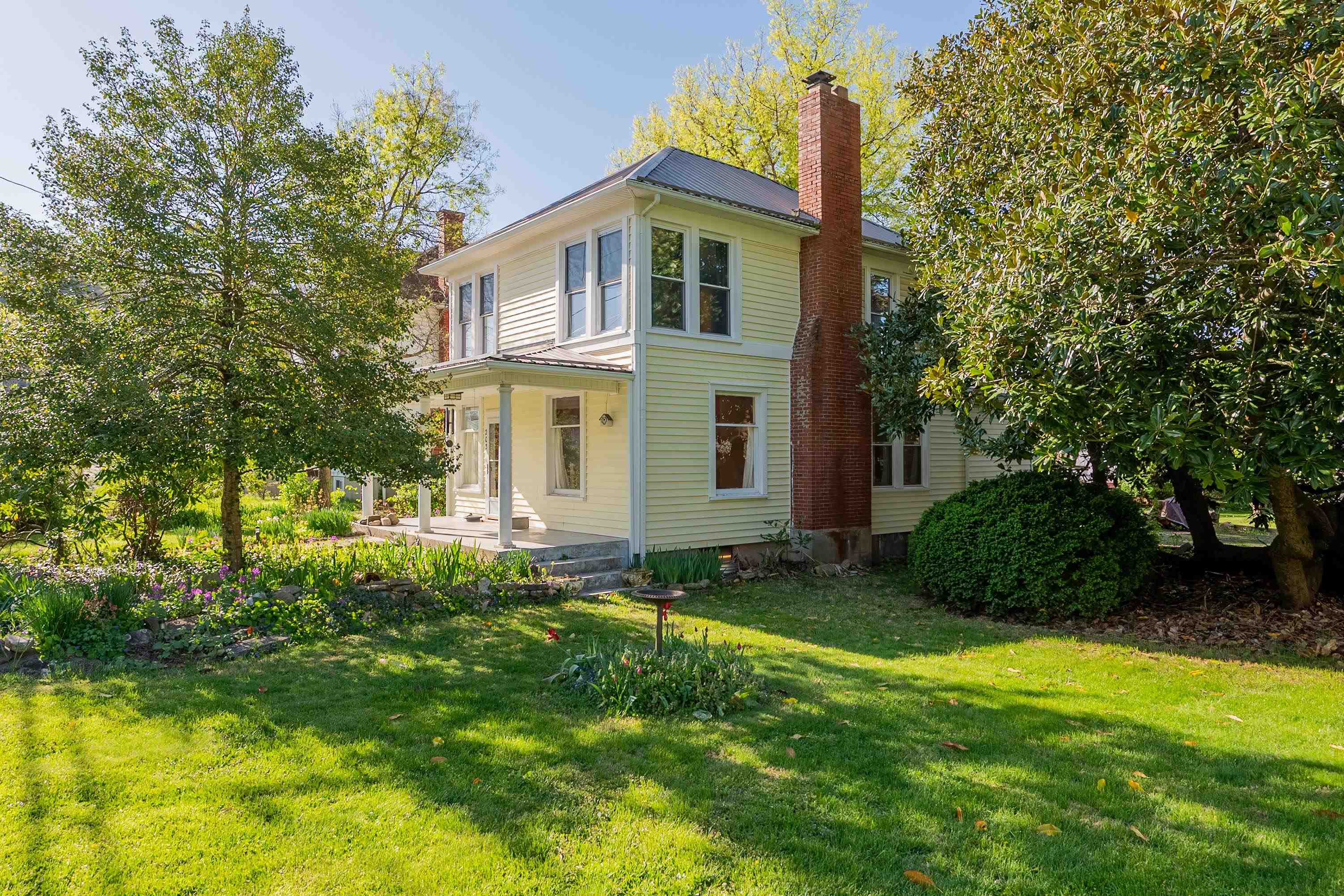 Welcome to 203 Snidow Street! The charming 1920's home has so many things to fall in love with and is a wonderful opportunity for someone looking to customize and polish this gem to make their own! First, the gorgeous, flat, yard that features beautiful and thoughtful landscaping with the most beautiful generations old magnolia tree makes for amazing curb appeal! The large covered front porch charms as you walk into the open living & dining space drenched in natural light, with tall ceilings, a gas fireplace, & original hardwood floors! The kitchen overlooks the lush backyard, and a laundry/mudroom makes for a great entry on the back of the house off of the driveway! Also on the main level are one bedroom and a half bath. Upstairs, you'll find four more bedrooms with large windows & tons of natural light & a full bathroom.