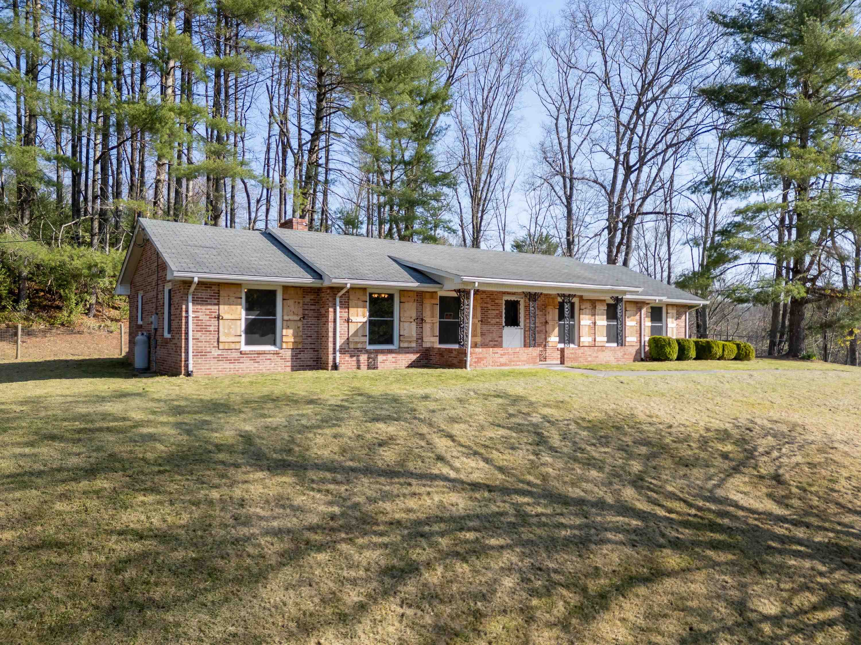 Charming 3-bedroom 2-bathroom brick ranch. This home provides privacy featuring a newly fenced yard making it ideal for kids, pets and simply enjoying the outdoors. Beautiful adjacent wood views. This is a well-maintained home with new windows for energy efficiency & natural light. New paint throughout, new pressure tank, conduct cleaning, Roof Maxx treatment. Large Master bedroom with on suite bath as well as 2 more spacious bedrooms. Large formal living area that has been opened up to created great flow with a formal dining room and Eat in Kitchen. Also enjoy a large family room featuring a wood stove insert. Just off the kitchen step into the sunroom that leads outside the property boosting a convenient carport and a two-bay detached shed ideal for storage, hobbies, or a workshop. Conveniently located to Riner, the Town of Floyd, Christiansburg or Blacksburg. This home is move-in ready and waiting for its next owner! Schedule a showing today!