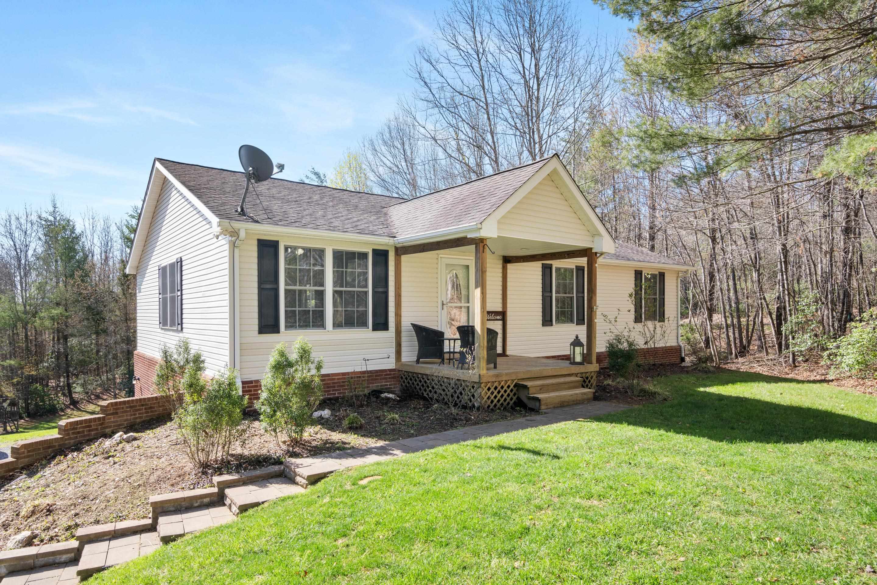 Welcome to 952 Dusty Rock! This spacious custom built 5-bedroom, 2.5-bath home sitting on right at 5 beautiful acres conveniently located between Christiansburg and Floyd is the perfect place to call home! Set back from the road, the home offers privacy and convenience.  Inside, you’ll find a generous open living/kitchen area, a master suite on the main level, lots of room to entertain in the basement, relaxing covered porch space, and so much more.  Don't miss the play area hidden under the stairs and the garden tucked away in the large backyard.  Make your appointment today for this rare find in a sought-after Floyd County location!