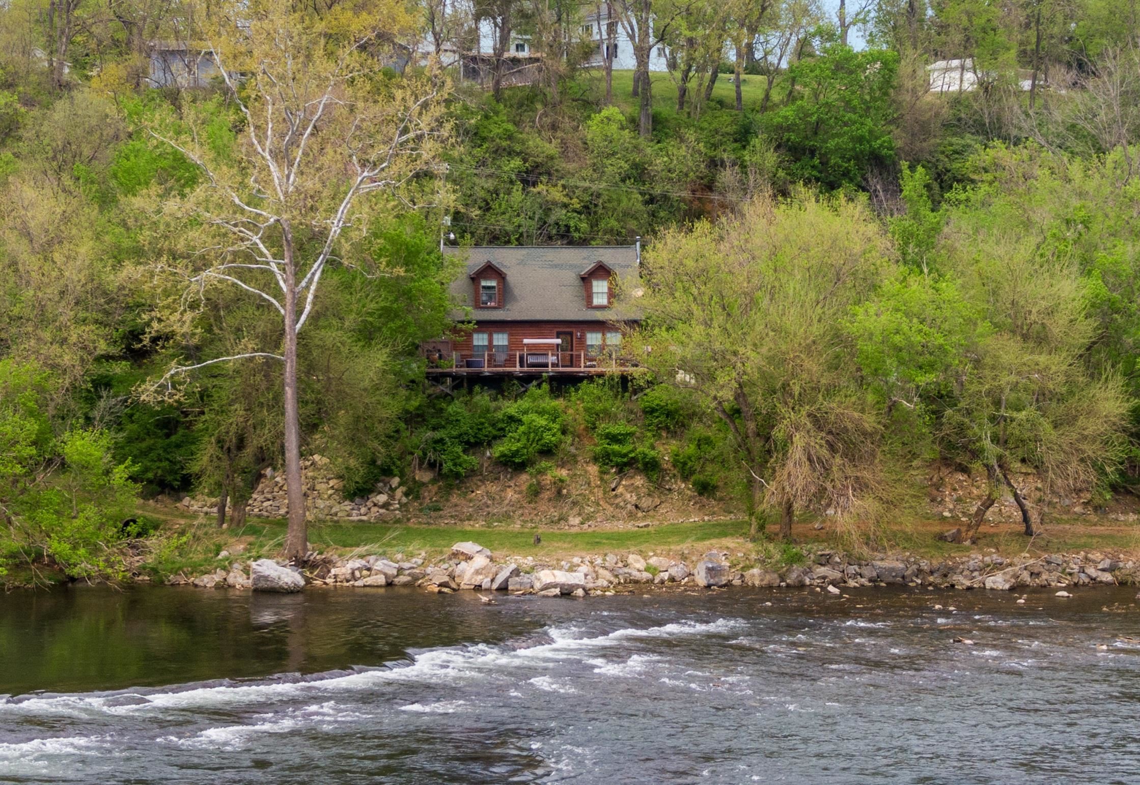 CALLING ALL OUTDOOR LOVERS—this riverfront retreat is the spot you've been waiting for! With 3 bedrooms, 2.5 baths, and non-stop fun just outside your door, it's the ultimate escape for anyone who lives for fresh air and adventure. LOVE TO FISH? Drop a line right in your backyard. Into kayaking, tubing, or swimming? The river’s ready when you are. Nature more your vibe? Deer stroll through the yard daily, and a brand-new trail next door is perfect for peaceful hikes or morning runs. Inside, the home is bright, comfy, and made for kicking back after a day in the sun. There's plenty of space for friends and family, whether you're grilling on the deck, telling stories around a firepit, or watching the sunset over the water. Whether you’re looking for a weekend getaway or a forever home, this place makes every day feel like a vacation. COME SEE WHY LIFE IS BETTER ON THE RIVER — you might never want to leave!