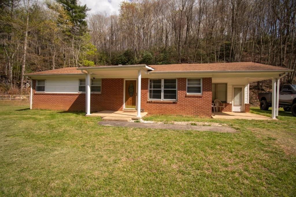 Well maintained brick ranch home set on 3 acres. Conveniently located between Stuart and Floyd VA. Easy commute to town of Stuart VA just minutes away, approximately 30 minutes to Floyd, and 40 minutes to Hillsville VA and Mount Airy NC. Home features 3 bedrooms and 1 full bath. Bonus room ready for your finishing touches! Full basement with wood stove and fireplace. Has a storage building. Beautiful level yard with mature trees along road for privacy and creek running through the property. Plenty of room for your garden! All wooded acreage behind the home.