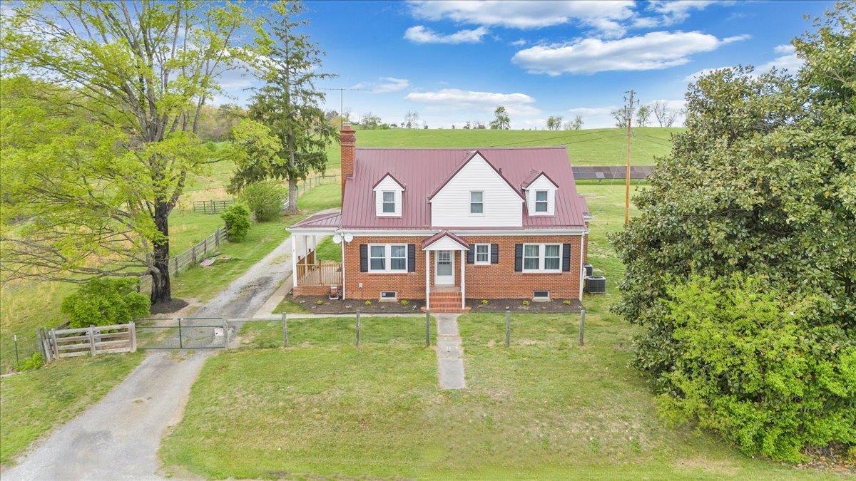 Welcome to this storybook brick Cape Cod that perfectly blends classic charm with modern sustainability! Nestled on a fully fenced lot that backs up to rolling farmland, this 4-bedroom, 1.5-bath home offers tranquility, character, and room to grow—inside and out.  Inside, you’ll find warm hardwood floors, cozy living spaces, and timeless details that make this house feel like home. The spacious basement offers endless potential—ideal for a home gym, workshop, or future living space.  The crown jewel? A powerful solar system that supplies the entire home with electricity and is fully capable of supporting off-grid living. Whether you're eco-conscious or simply love the idea of energy independence, this system has you covered.  Enjoy the serenity of wide-open views, peaceful mornings on the porch, and stunning sunsets over the neighboring farmland—all while being just 20 minutes from the heart of Blacksburg, home to Virginia Tech and a vibrant downtown.  Don't miss your chance!