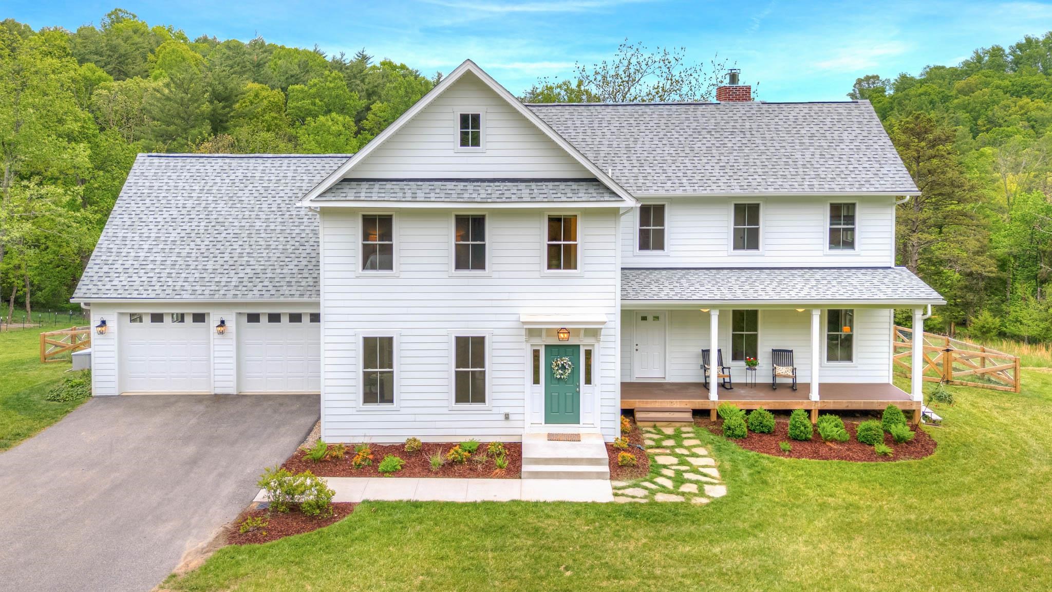 Dreaming of the country lifestyle just 15 minutes from downtown? This custom built modern farmhouse is sure to please. Satisfy your culinary craving in this impressive kitchen with large island, quartz countertops, induction range, two sinks & an abundance of cabinets. Cozy up to the Rumford fireplace in the adjacent living room with built-in shelving. Main level primary bedroom provides an option for those that need one level.  The upper primary suite is conveniently located near 2 add’l bedrooms with jack-n-jill bath, upper living room, office & bonus room for a studio, workout area, or storage. Large windows provide natural light to invite the outdoors into your view from every room. Oak wood floors throughout, solar panels & whole house generator are added bonuses. Explore the creek and forest, relax on the front or back porch, play in the fenced yard, enjoy s’mores on the patio's fire pit. Chicken coop for fresh eggs, blueberry bushes & young apples trees complete this gem!