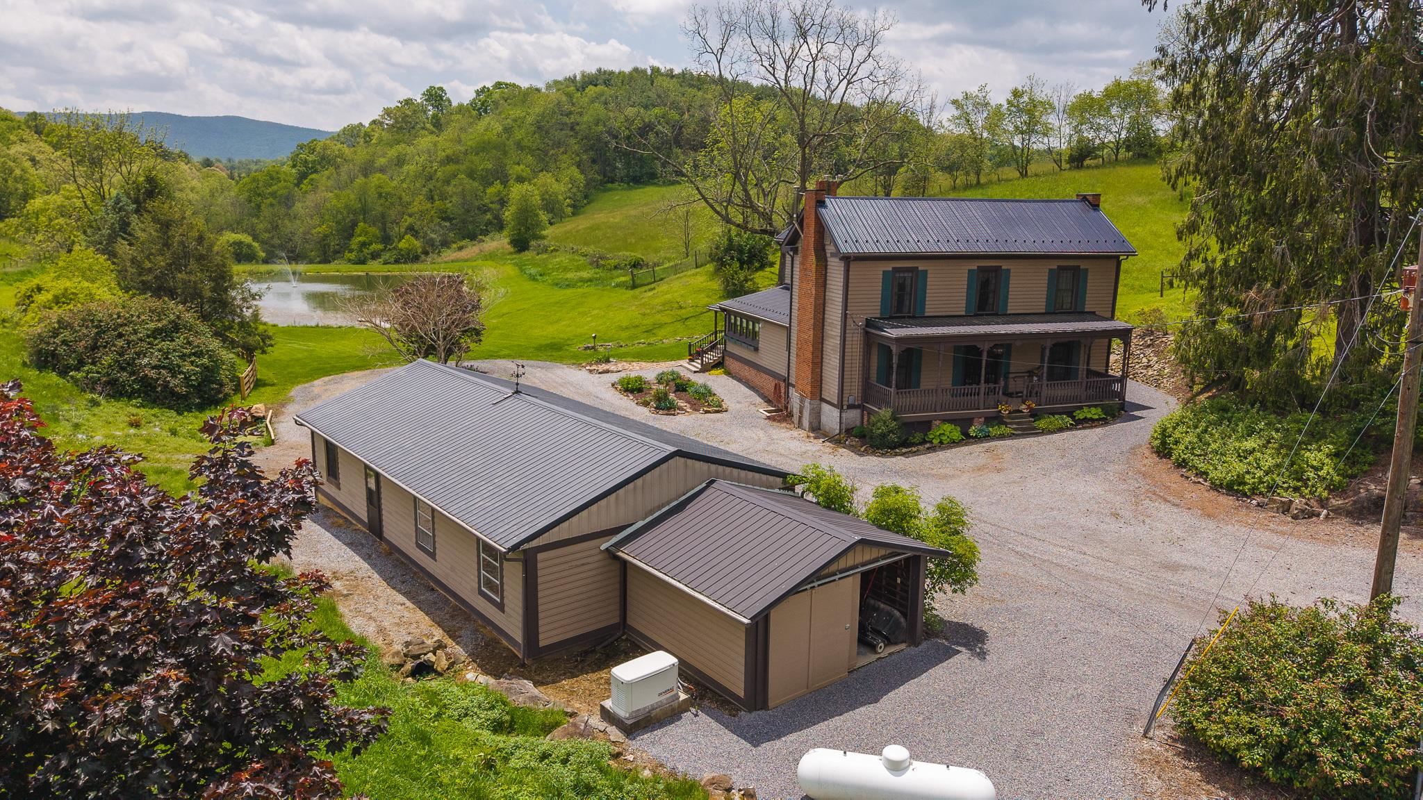 Auction Property: List price may not reflect final sales price. List price is starting bid and non-reflective of value. Auction Ends Thursday, June 26th, at 4 PM. Are you looking for a farm in the Blue Ridge Mountains? This 203.5 acre farm in Rural Retreat, VA has it all with fenced pastures, woodland, creek frontage, a pond, views, multiple barns and a charming farmhouse! Don’t miss your chance to own this one of a kind property! The land has a mix of open pastures and woodland totaling in just over 203 acres. There is +/- 102 acres of fenced grazing farmland. The board and wire fence are in good condition.  The farmhouse, which was built in 1850, has been renovated and updated. It is in very good condition. There are 5 bedrooms, 2.5 baths, and 2,898 sq ft. The spring fed pond, sits below the home, and is about 0.71 acres. Approximately 1/2 mile of Big Branch Creek runs through property. Property has 2 private wells and a septic system.