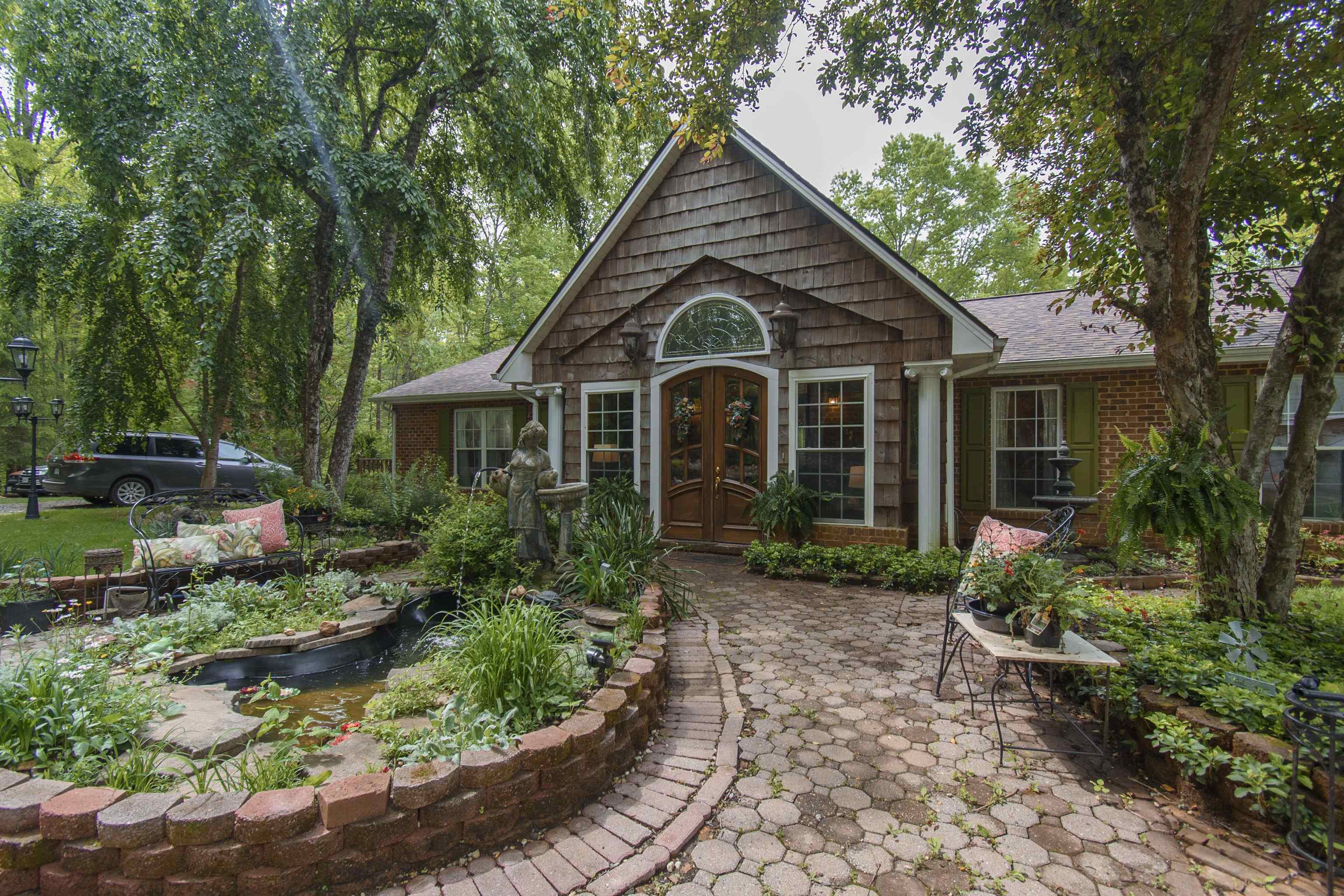 Discover old world charm in the heart of the Appalachian mountains in this custom built home. Situated at the top of a 10 acre wooded parcel, this home offers privacy in a story book setting.  There is plenty of room for the family. A fully finished basement which can serve as separate living quarters boasting its own kitchen, bathroom, bedrooms, two wood stoves, living space, deck and separate entrances. The space above the spacious three-car garage, can be finished to accommodate guests or converted to a short term rental.  The large wrap around decks on the house and decks off the garage provide multiple outdoor spaces for entertaining or enjoying the wild life. Just a short distance from trout fishing in Burks Fork Creek (stocked by the state),the Buffalo Mtn Preserve and less than 15 miles to the iconic town of Floyd, you have easy access to outdoor adventures as well as arts & entertainment. Be sure and check out the link to the virtual tour.