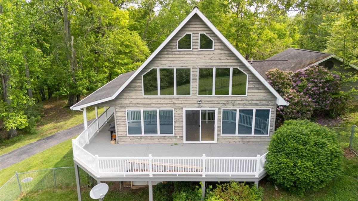 Enjoy comfortable country living on a private 1.78-acre lot with the convenience of main-level living. Inside, the light-filled vaulted great room is the heart of the home with a wall of windows, gas fireplace & open kitchen and dining room, plus newly refinished hardwood floors and fresh paint. The kitchen has a long breakfast bar, cherry cabinets and Corian countertops. The main-level primary suite features a large bath w/double sinks, jetted tub and separate shower. Laundry room w/extra storage and utility sink leads to the double attached garage. Upstairs is loft and second bedroom with private full bath. In the basement is a large, walk-out family room, powder room, third bedroom & utility/storage room.  Entertaining and living area is extended outside on the wrap-around covered front porch & plenty of room for a grill, table and seating on the open deck. The large yard has a fenced-in area for pets. Generac generator provides emergency power if needed. Call for a tour today!