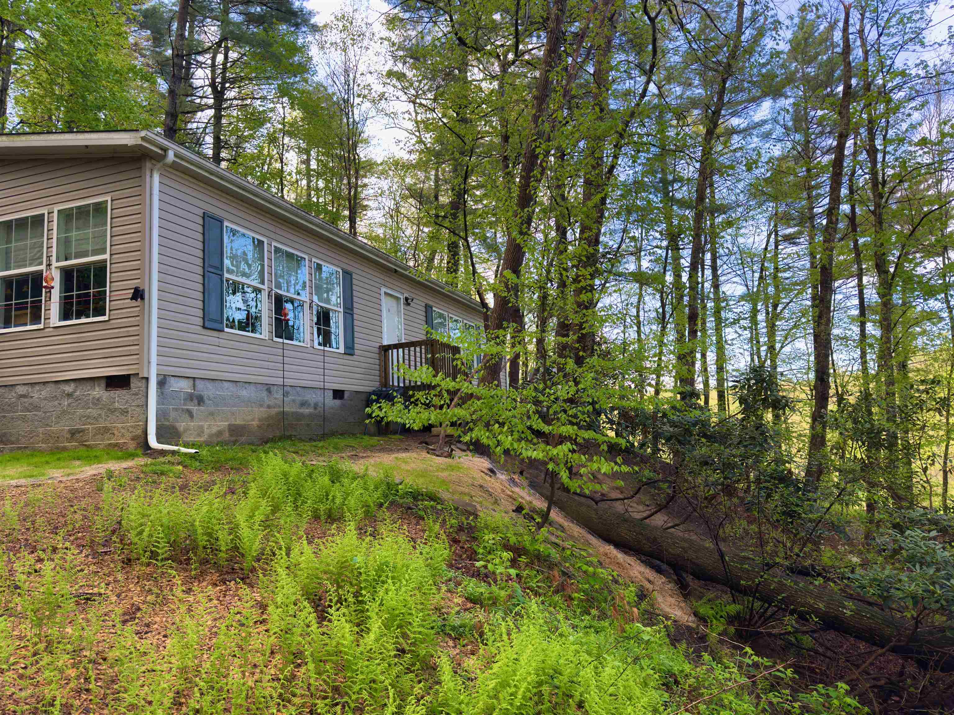 Perched among the trees with seasonal Blue Ridge views, this private 2014 home offers a treehouse-like experience on 1.41 acres with Crooked Creek frontage, a pristine, trout stream. This 2 bed/2 bath retreat features water access at the lower lot perfect for camping and gatherings. Includes backup generator, storage shed, and private road setting. Minutes from Crooked Creek Wildlife Management Area, horse trails, and New River. Showing by appointment only. Scroll to the end of photos to see the wildlife the owner will miss most about this special place. This woodland hideaway awaits its next nature lover!