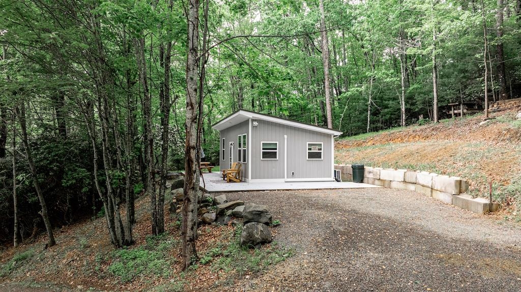 Check out this Blue Ridge Mountain Getaway! This Tiny Home was built in 2023 on +/-1 ac of wooded seclusion on the foothills of Buffalo Mountain. Just 6 miles to the Blue Ridge Parkway, 17 miles to both Floyd and Hillsville, VA. The Tiny Home boasts 1 bed, 1 full bath and kitchen/living area. This 420 sq ft low maintenance Tiny Home is not lacking in amenities. A large wrap around patio allows for unlimited outdoor enjoyment, complete with BBQ grill, fire-pit, large octagon picnic table and comfortable Adirondack chairs to enjoy nature. The home is being sold fully furnished. All household goods included, so just bring your toothbrush. Conveniences include insta hot water, mini split heat and air, wired for a generator, gated driveway, equipped toolshed and high speed internet available.