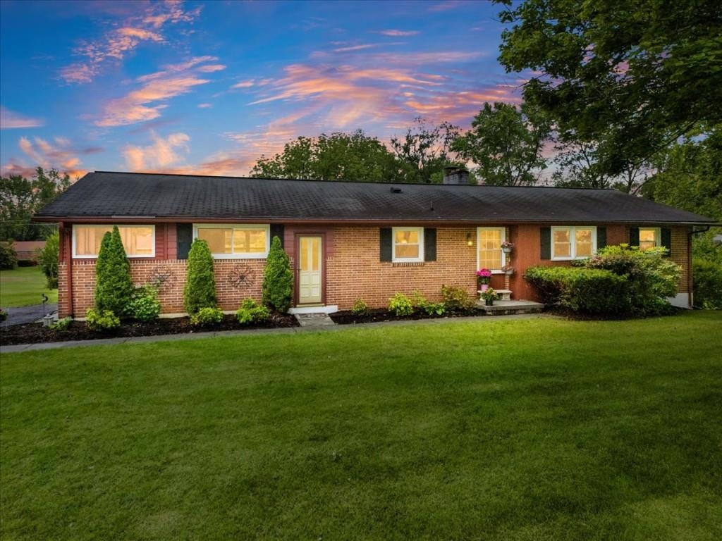 Spacious brick ranch is move-in ready with the flexibility to update at your own pace! Discover hardwood flrs, 2 fireplaces, remodeled kitchen, brick accents & expansive rooms filled with natural! PLUS, a new outside HVAC unit in May 2025 with 10yr warranty that transfers to new owners!! Classic paneling & exposed brick add warm, nostalgic appeal in the oversized living rm. Granite counters, tile backsplash, beautiful cabinetry & full complement of appliances in the remodeled kitchen that is as functional as it is beautiful! Dining rm is brightened by natural light from large picture window & warmed by a wood-burning brick fireplace. The sunroom creates a comfortable space where you can savor a leisurely day. 3 beds w/dbl closets & hardwood flrs ready to be refreshed! Full bath w/shower 2023. Basement family rm is 3/4 finished & primed for personal updates. 0.81-acre lot framed by mature trees. 2 blueberry bushes! Full of potential & an excellent opportunity for the budget-conscious!