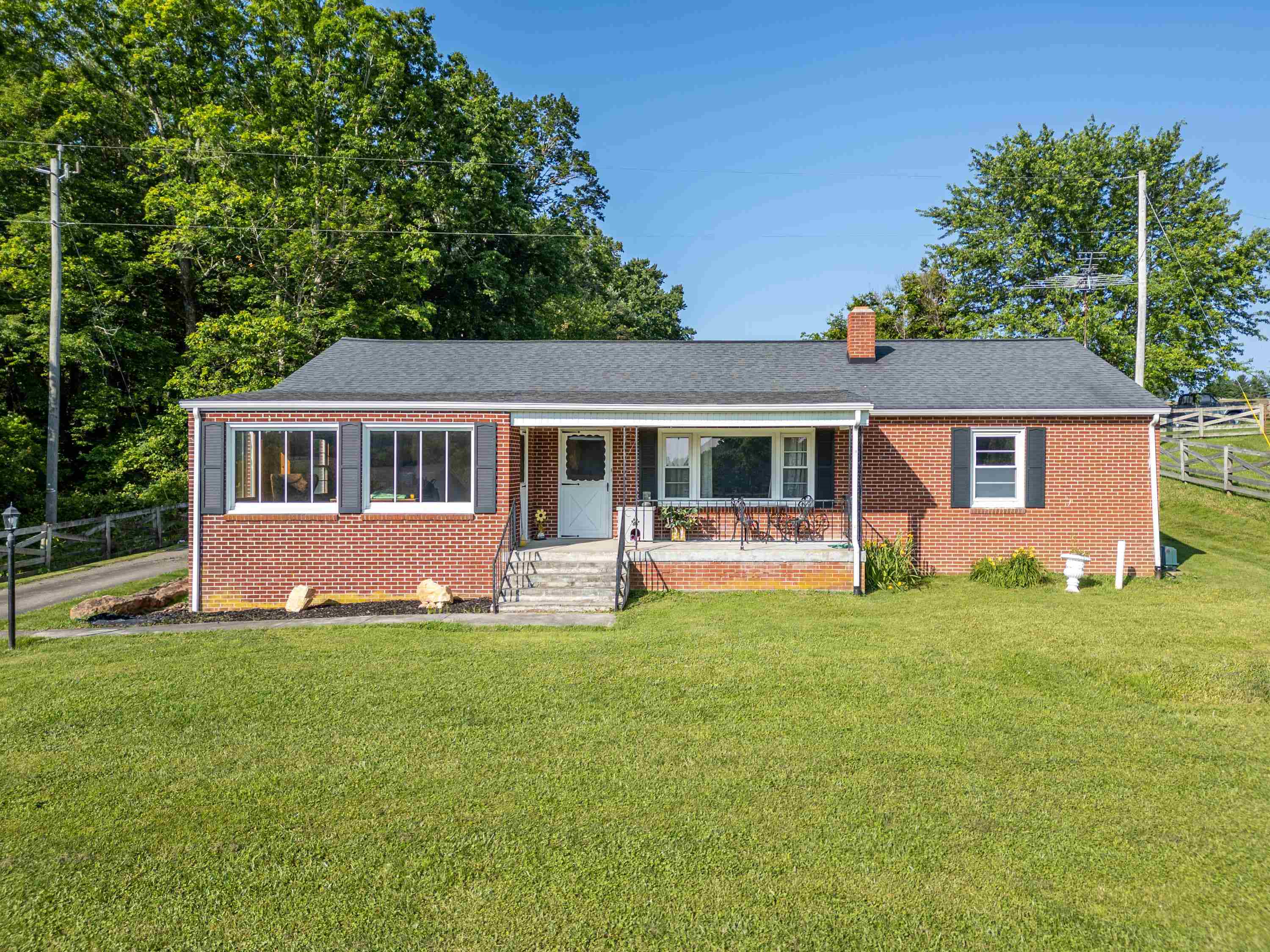 This classic brick ranch with 3 bedrooms and 1 bathroom features a timeless layout full of potential and charm. Perfectly situated near Willis Elementary School, 15 minutes to the Town of Floyd, this home combines the peace of country living with convenience to town. Step inside to an open kitchen and dining area, large living room and potential for creating an open concept entertaining space or formal dining room. A full basement offers ample storage, a home office or finishing for additional living space. The kitchen connects to an enclosed breezeway that leads to a two car garage ideal for tools, hobbies or extra storage. Outdoors, enjoy a spacious yard for gardening or entertaining. Don't miss out on the opportunity to make this house your home!