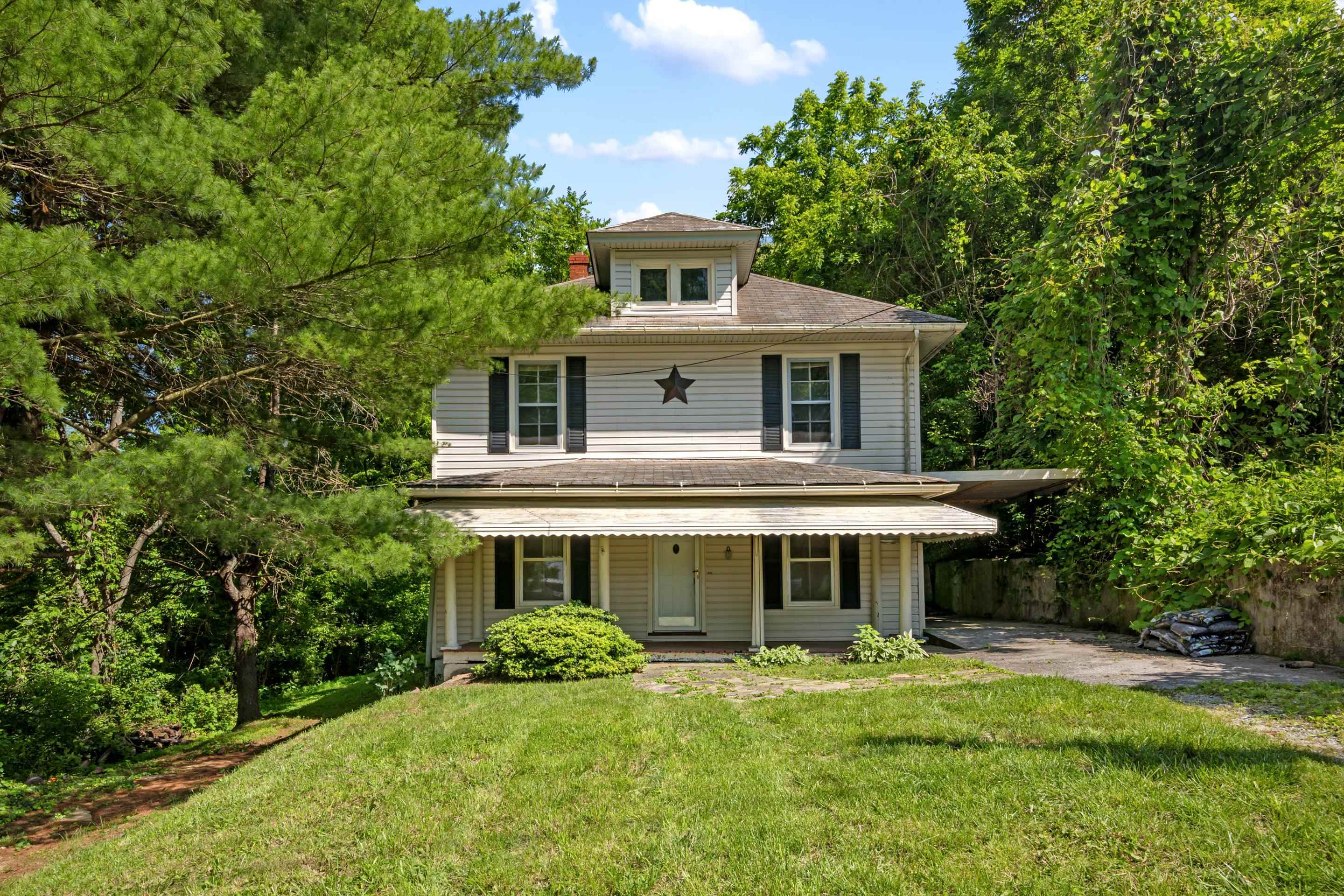 This charming 3-bedroom, 2-bathroom home is full of character and potential, nestled among mature trees that offer privacy and shade. Featuring a spacious kitchen with ample cabinetry and natural light, it also includes a finished attic, perfect for a fourth bedroom, office, or creative space. With unique architectural details and a welcoming covered front porch, this home is looking for its next owners to bring their vision, make it their own, and restore its full charm.