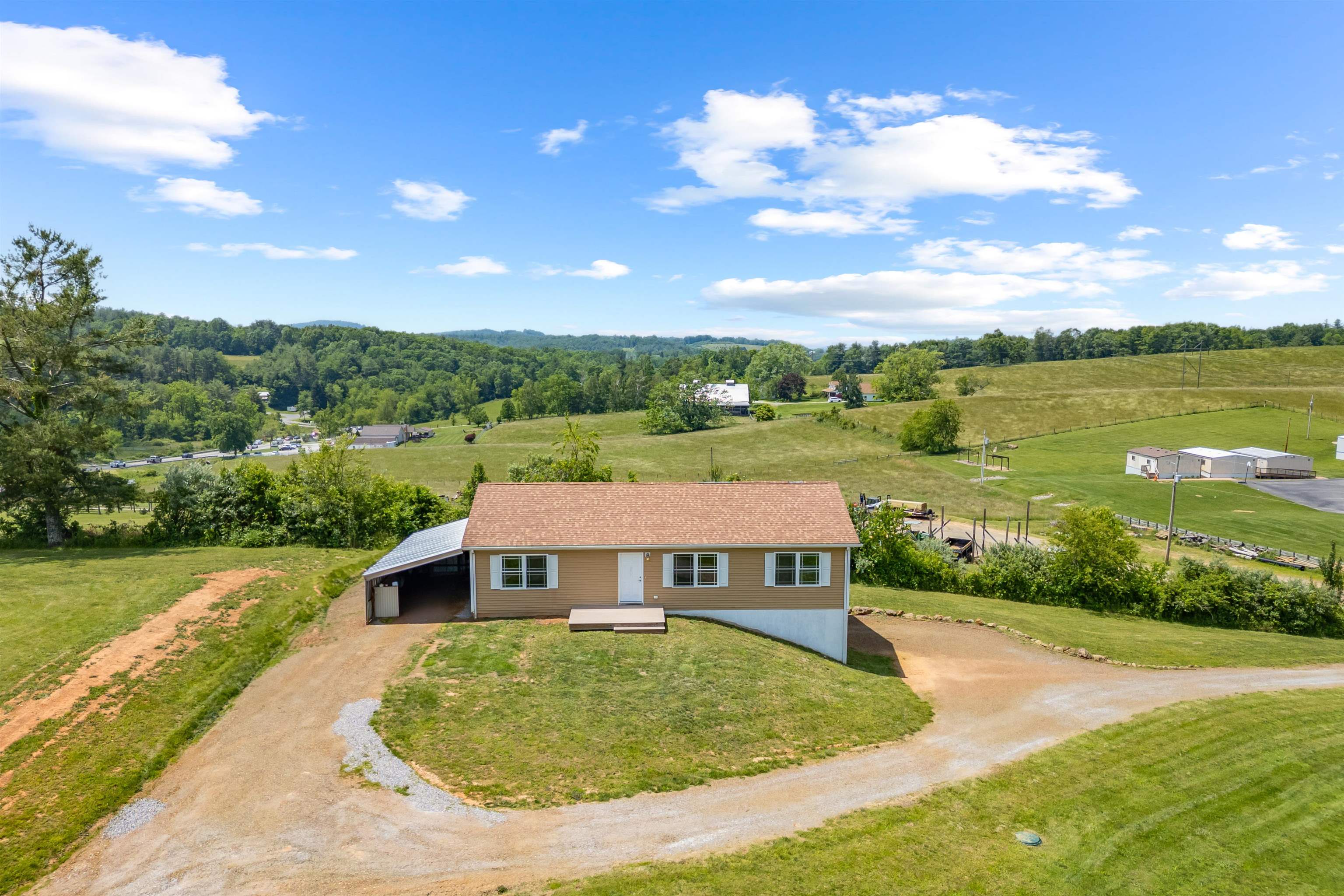 Just 5 minutes (3.8 miles) from the light in Floyd and in sight of the Bread Basket, this cute little house is perfectly situated to commute to Floyd, Christiansburg, Radford, Blacksburg, or work from home. It's completely fenced for dogs, with a productive apple orchard, and plenty of sunny space to garden or keep chickens, goats, or a pony. This house is solidly built with a functional basement with ground level drive up access to store machinery or adapt to a separate living area. The basement is plumbed of a third bathroom. In the orchard there are two grave stones dating in the 1800s. Don't miss this opportunity to own the property with so much potential to fulfill your needs and dreams.