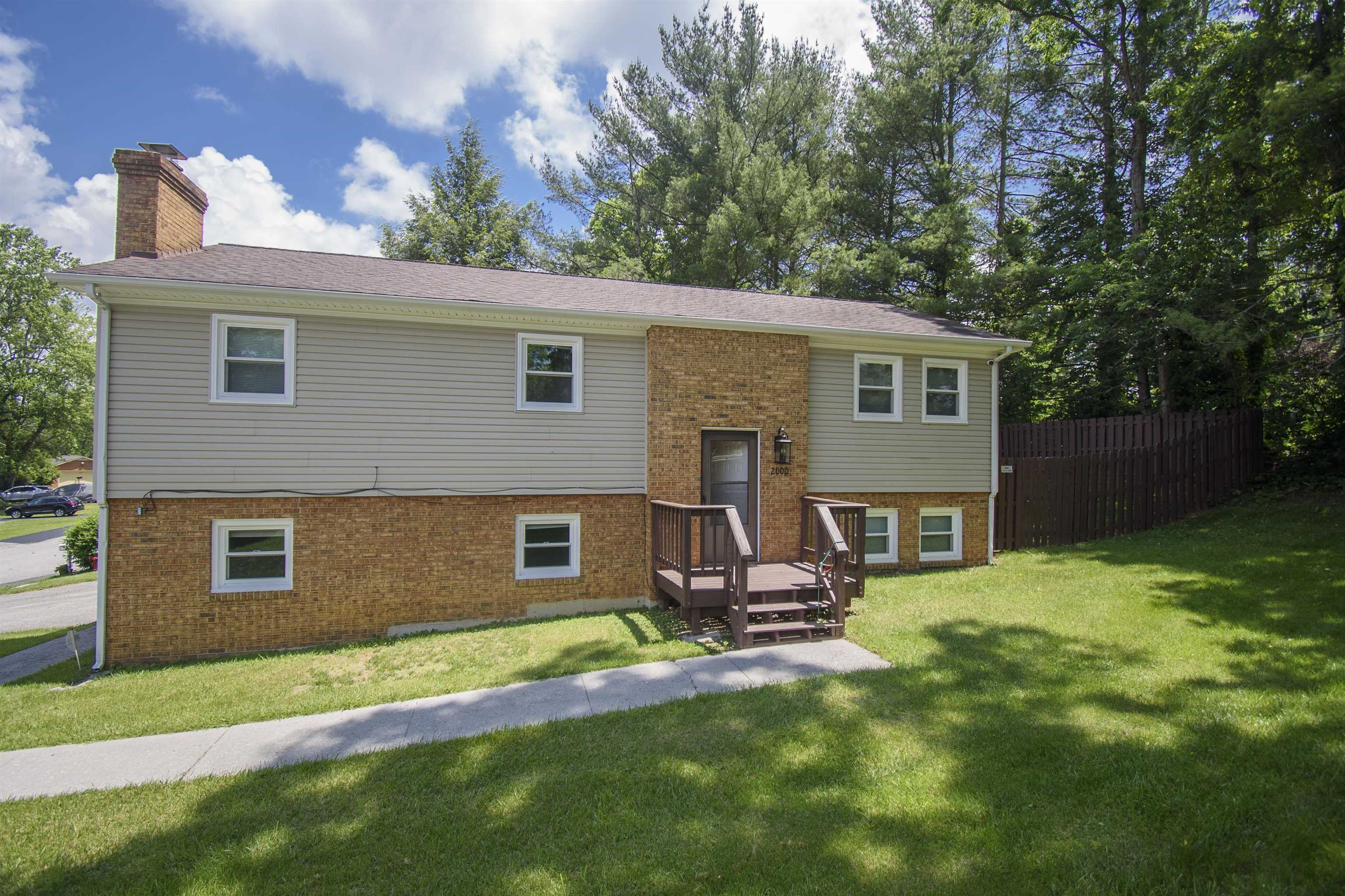 Just minutes from downtown Blacksburg, this cozy split-level home is full of updates and charm. The main level features a spacious living room, dining area, and an updated kitchen with brand new granite countertops, new appliances, cabinets, and lighting. A sliding door off the dining room opens to a private deck—perfect for relaxing or entertaining. Three bedrooms, including a primary suite with a private bath, are also on the main level. The entire home has fresh paint, brand new carpet, new windows, new blinds, updated light fixtures and faucets, plus ceiling fans in every bedroom and the living room. The lower level offers a second living area with a fireplace, a fourth bedroom, a third full bath, laundry area, and garage access. Outside, enjoy a fully fenced yard—ideal for pets or play. With so many updates and a great location, this home is move-in ready!
