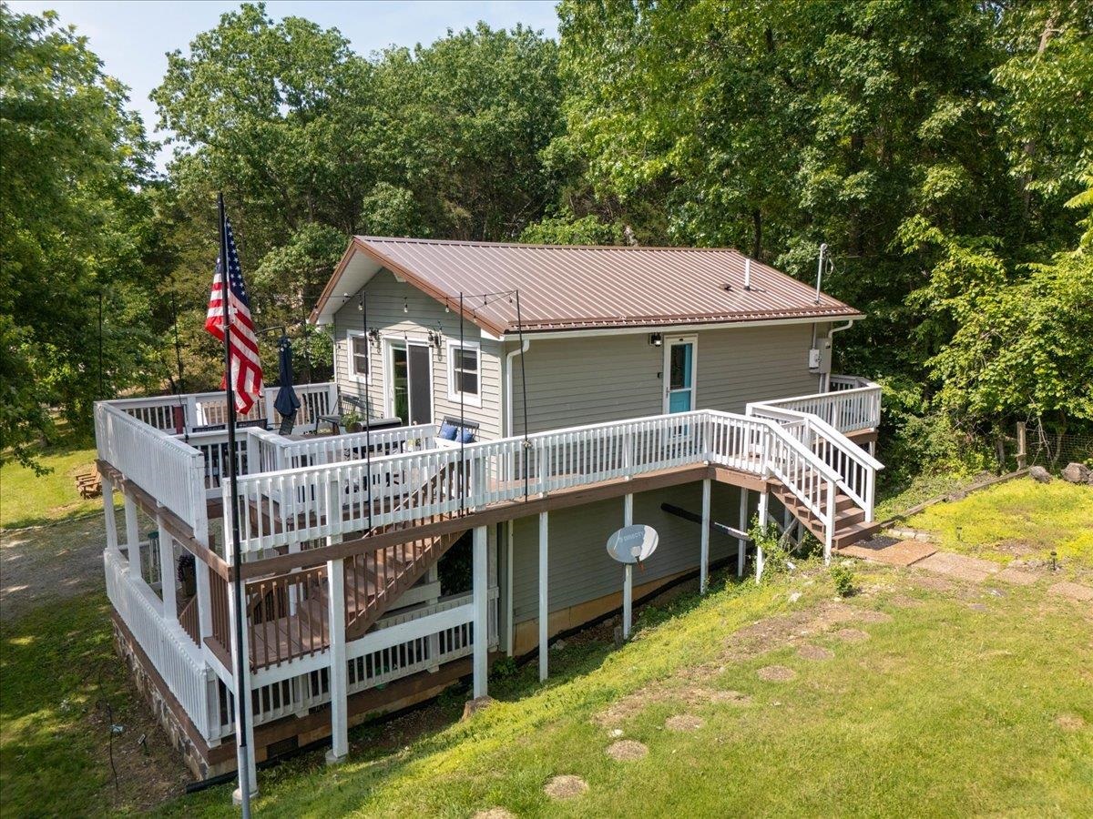 Charming, fully-furnished one-bedroom, move-in-ready lake view cottage nestled on 1.3 serene acres! Perfect as a peaceful getaway or an income-producing Airbnb, this cozy retreat offers stunning views, modern comforts, and endless potential. Whether you’re looking for a weekend escape, a short-term rental investment, or a place to build your dream home overlooking the water, this rare property checks every box. The spacious lot provides room to expand or construct a custom residence while enjoying the existing cottage. Don’t miss this unique opportunity to own a lake-view property with both immediate use and long-term vision. Currently used as an AirBnB with a great rental history. This property does have deeded lake, dock, and boat ramp access. Please schedule through Sentrilock. The listing agent is related to the seller.
