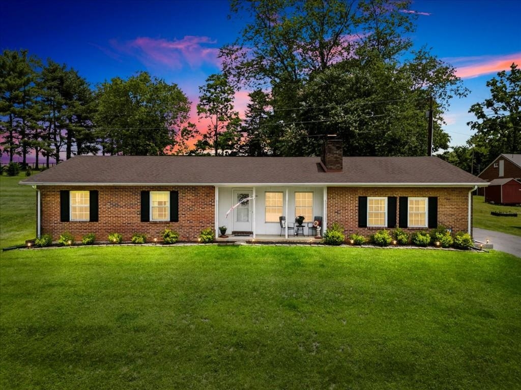 Nestled in a lovely neighborhood, a tree-lined street welcomes you to this delightful 3-bed, 2-bath brick ranch designed to impress & ready to feel like home! Spacious family rm made extra inviting by charming, all-brick wood-burning fireplace. Easy care tile flrs & abundant natural light streaming in through numerous windows. Step up into a generous eat-in kitchen loaded w/cabinet & counter space, full complement of appliances and breakfast bar. Seamlessly flowing into dining rm where modern chandelier lights way for hosting relaxed dinners or larger gatherings. Cozy living rm with its own front entrance beneath cozy covered porch just waiting for rocking chairs. 3 bright bedrooms w/plush carpet & ample closet space, including primary with a private full bath. Partially finished basement offers a large den & 1100+ sq ft of unfinished space providing exciting expansion potential. Generous screened-in patio for unwinding without worry of insects or inclement weather. Let's go look!