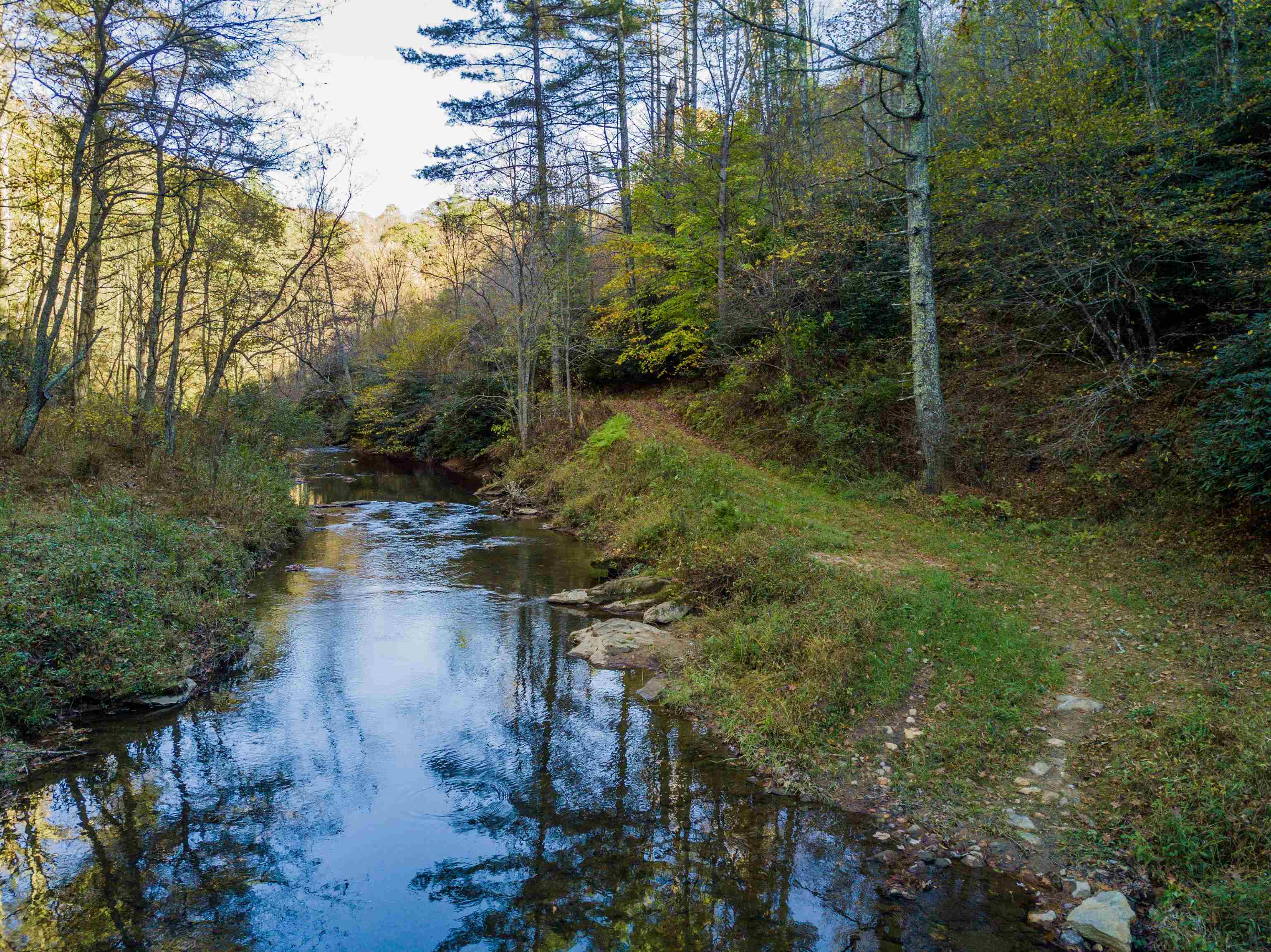 Truly and one of a kind property!  145 acre with almost a mile of 40' wide river frontage that you would own on both sides, the Lost River property is something nature lovers will really appreciate. Multiple building spots include down by the water or up top with great sunset mountain views, this is the perfect place to build your dream home or come visit for weekend retreats! Trails run throughout the property suitable for walking, horses, ATV's or SUVs. There is an abundance of wildlife and would be a great location to stock trout. Besides the river, there is another 2,300' of creek frontage as well. All the privacy and seclusion you want, but only 30 minutes from either I-81 or I-77 making it easy to get to. And you can enjoy this rural country living while also having access to fiber internet up to a Gig speed! Come visit this property today!  Property is Owner/Broker and Buyer to verify any information.