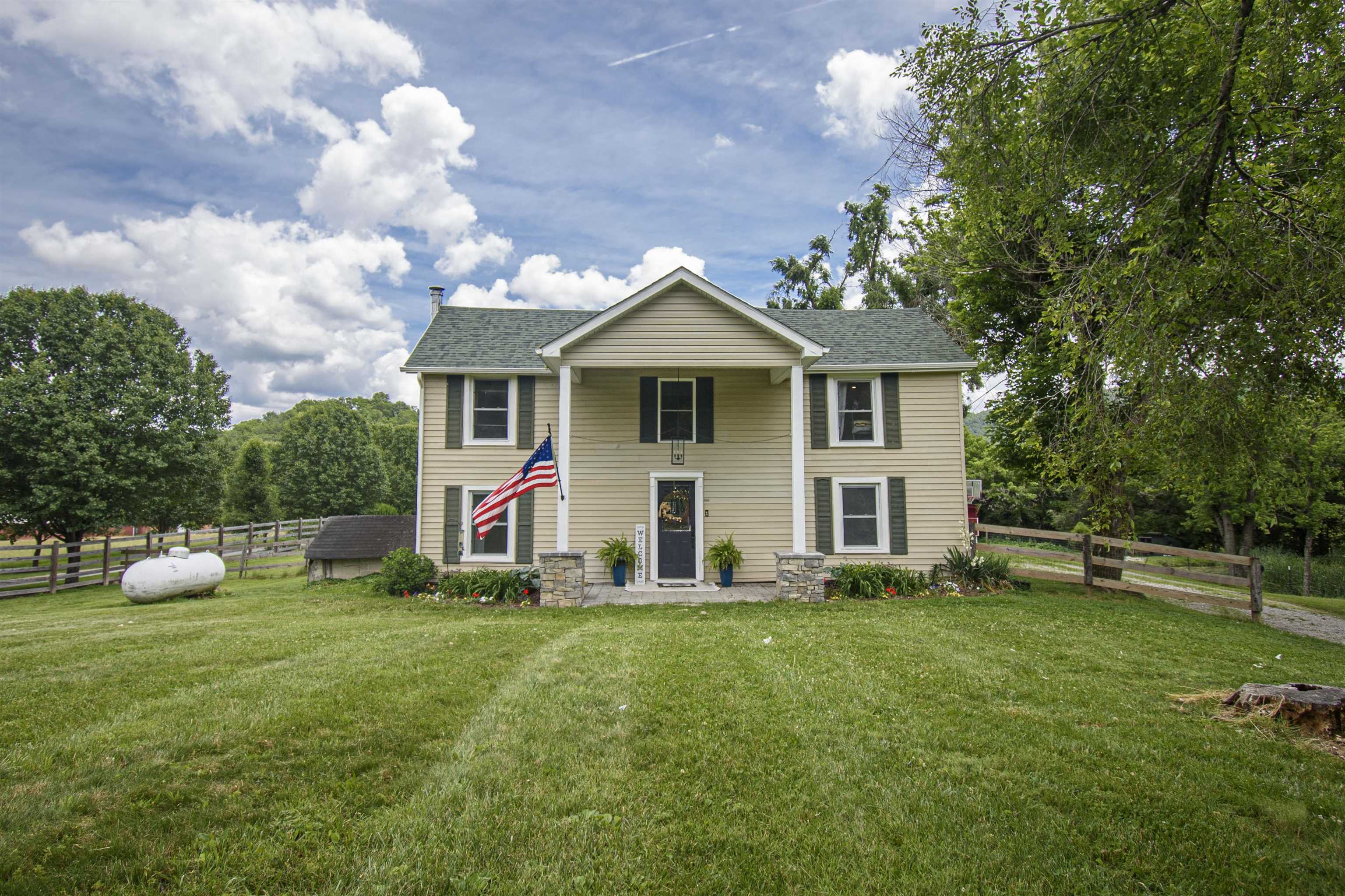 Nestled in the picturesque Ellett Valley, This updated home offers a serene blend of historic charm and modern comforts. This 1910 farmhouse, situated on approx. 3.6 acres within the sought-after Blacksburg School District, boasts captivating mountain views and a tranquil pond oasis. The home encompasses 2,432 sq ft, featuring 3-4 bedrooms and 2 full baths. The "Den" on the main level offers potential for a 4th bedroom.  The main level offers refinished hardwood floors, while the upper level showcases new flooring throughout. Recent enhancements include updated kitchen, bathrooms, electrical and plumbing systems, a newer architectural shingle roof (2022), and a well-insulated structure. The home is equipped with zoned heating, a propane furnace for auxiliary backup, and cozy wood stove in the living room. Enjoy the scenic beauty from the side patio, overlooking the stream-fed, aerated pond. The property also features a gazebo, chicken coop, shed, and a large fenced yard.