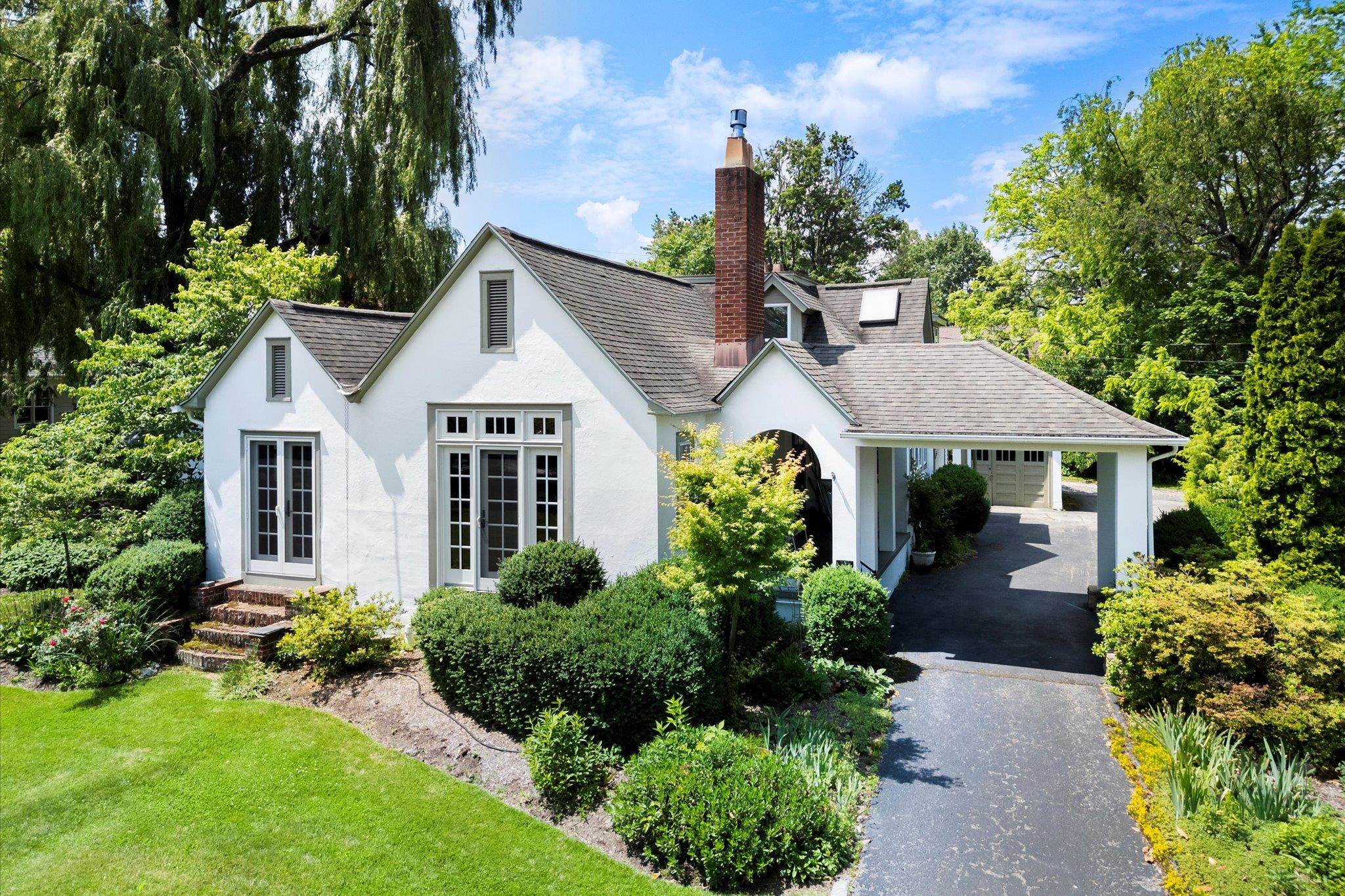 This Blacksburg home offers in-town living and the solitude of a private garden. Combining both location and charm; a 10-minute walk to downtown and Virginia Tech. Built in 1926 with an Arts and Craft flair, and renovated to offer a unique, spacious layout. This home includes a living room with vaulted ceiling, gas fireplace, and oak trim, a welcoming space for every holiday. A spacious dining room, cozy family room, functional office, and studio, designed to cater to comfort and creativity. A welcoming kitchen with cherry cabinets, and breakfast nook overlooking the enchanting garden. With 3 bedrooms and 3 full baths, there's plenty of room for family/guests. The main-floor primary bedroom was added in 2005. It boasts 2 large closets, gas fireplace, and en-suite bath. Seamless indoor/outdoor living is accessible from family room and primary bedroom to the “best room in the house”, a hardscape patio overlooks a peaceful garden and pond, the perfect getaway, right in the center of town.