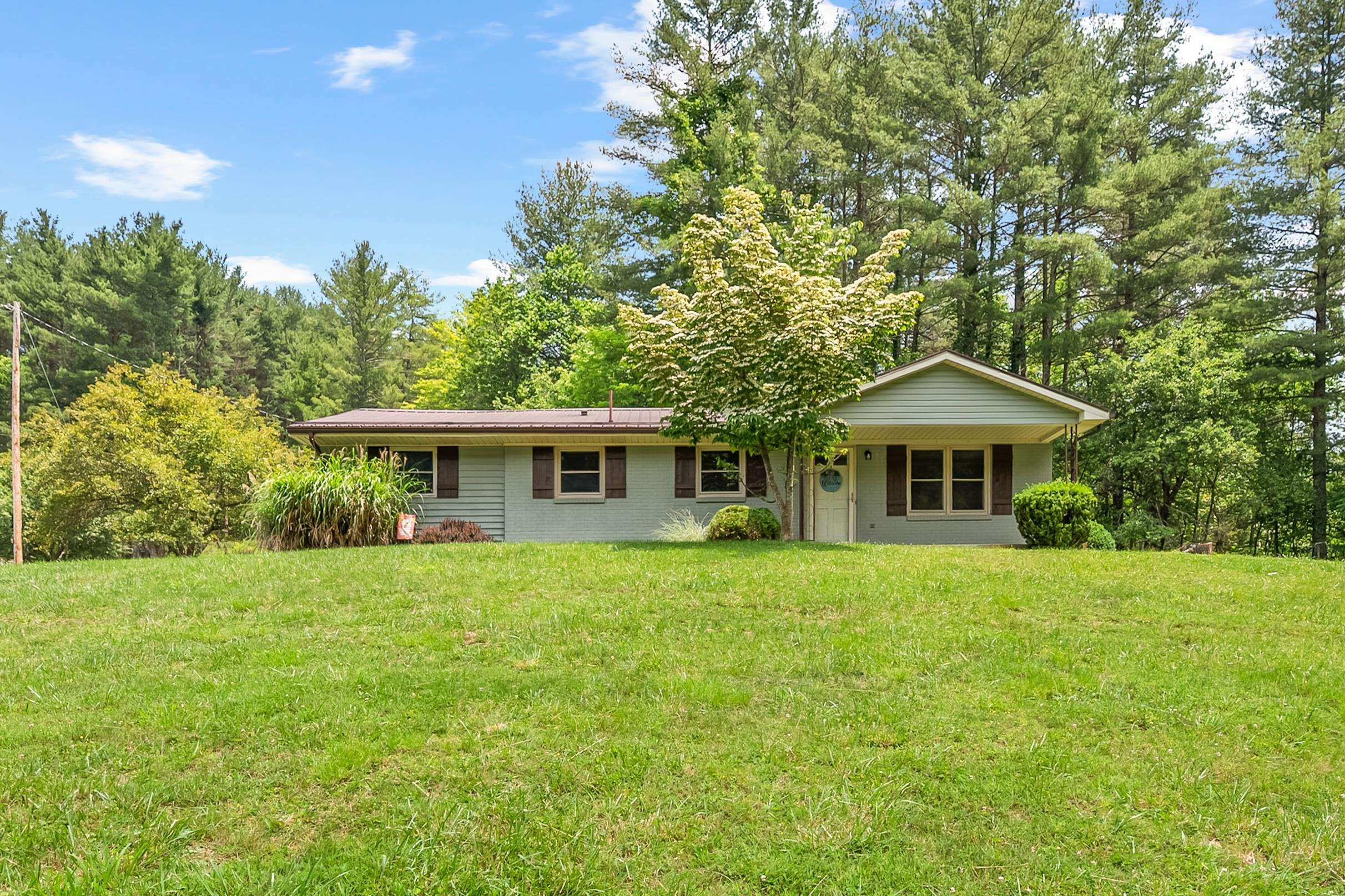 Seize this rare opportunity to own a charming ranch-style retreat just minutes from Radford and Interstate 81, nestled on a generous 0.63-acre lot in a neighborhood where homes are seldom available. Tastefully updated throughout, this home features new paint and flooring in a light, neutral palette that feels fresh and welcoming. Inside, you’ll find two bright, comfortable bedrooms on the main level, while the basement offers a versatile non-conforming third bedroom, perfect for guests, office space or storage. The inviting entry living room flows seamlessly into a practical eat-in kitchen—an ideal setup for family life and casual entertaining—while the back deck, overlooking a spacious backyard, presents a serene space for children’s playtime, gardening, or outdoor relaxation. With its appealing blend of functionality, updated finishes, and convenient location, this home offers a peaceful, single-level lifestyle with just enough bonus space to suit a variety of needs.