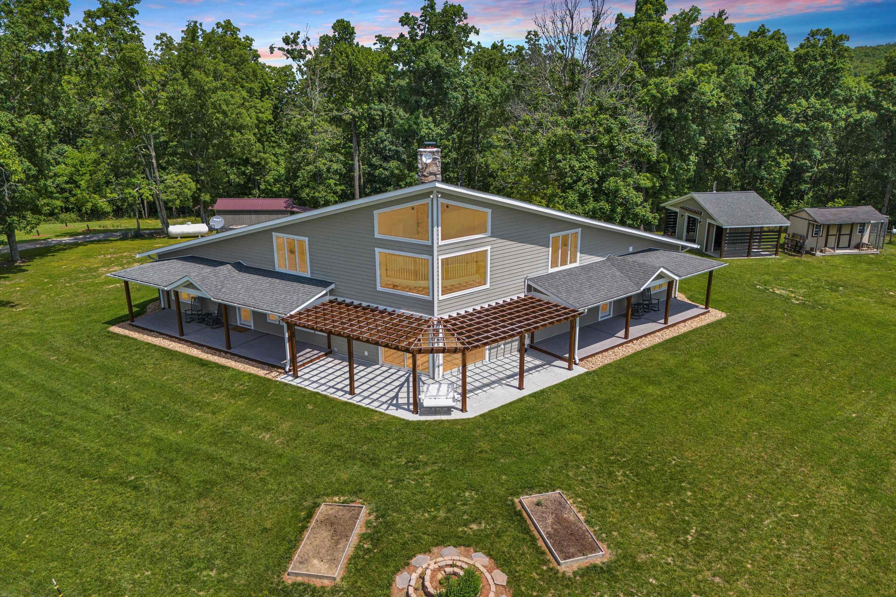 Check out this absolute showstopper on top of Pilot Mountain!! This unique and architecturally stunning home combines rich comfort with peaceful country living. The kitchen features granite countertops, rich wood cabinetry, stainless steel appliances, and a subway tile backsplash. The spacious first-floor primary suite includes dual vanities, a freestanding soaking tub, a custom shower with two shower heads, and a huge closet. Open living spaces are filled with natural light pouring through large windows with high end finishes throughout including a masonry wood-burning fireplace. An outdoor wood furnace keeps energy bills low, offering an energy-efficient solution for year-round comfort and a full-house Generac generator provides coverage for any unanticipated weather. Enjoy serene mountain views, a large yard ideal for gardening or recreation, and the quiet charm of rural life—all while being within a reasonable drive to town.