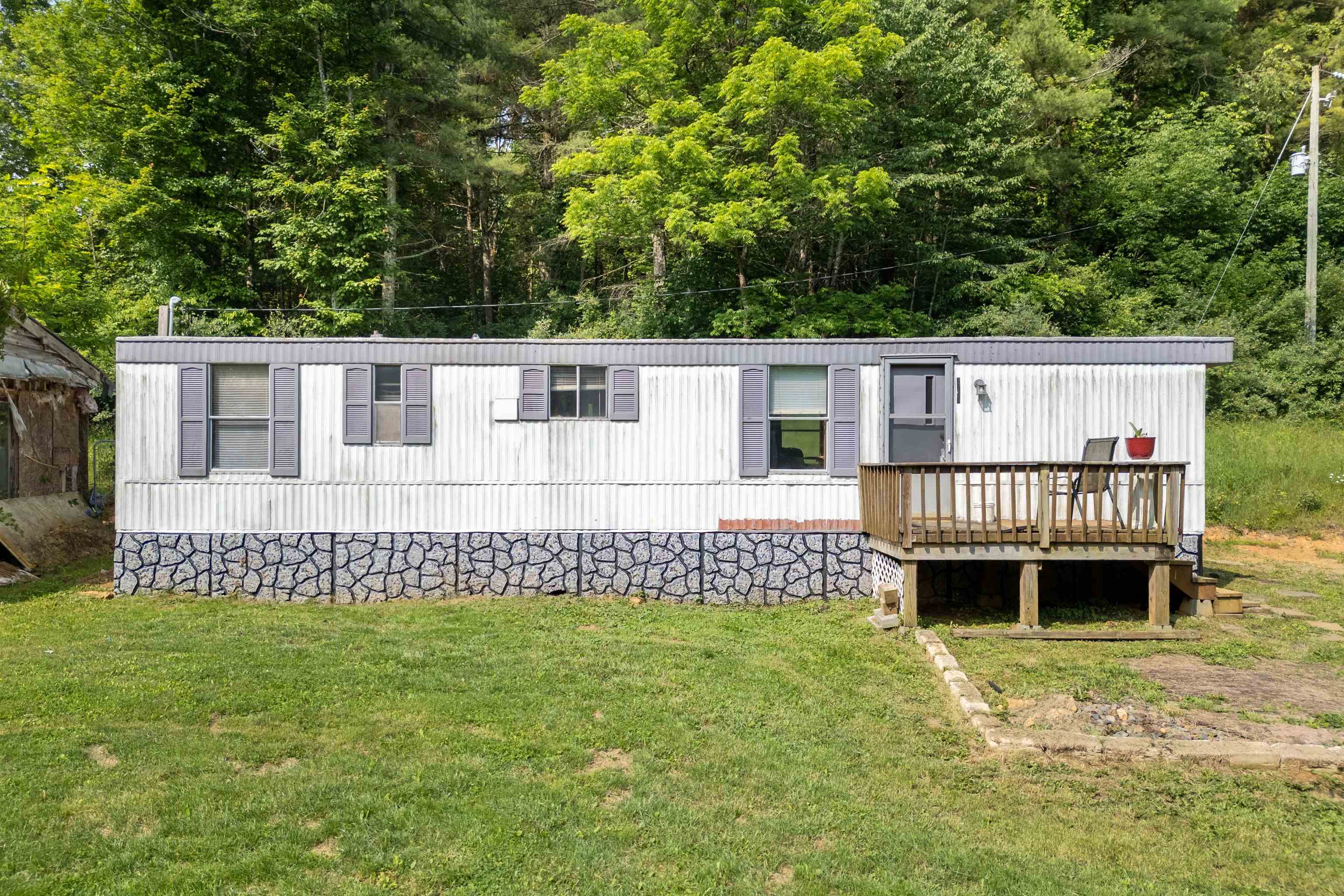 Single wide mobile home on 3.25 acres in a peaceful country setting. This 2 bedroom 1 bathroom home needs some TLC but offers solid potential for a weekend getaway, rental property, or a primary residence. Being sold AS-IS, making it perfect for handy buyers or investors looking for their new project. There is a spring fed pond filled with coy fish to enjoy, room to run around outside and a possible second residence with potential to be fixed up. Call today to schedule a showing!