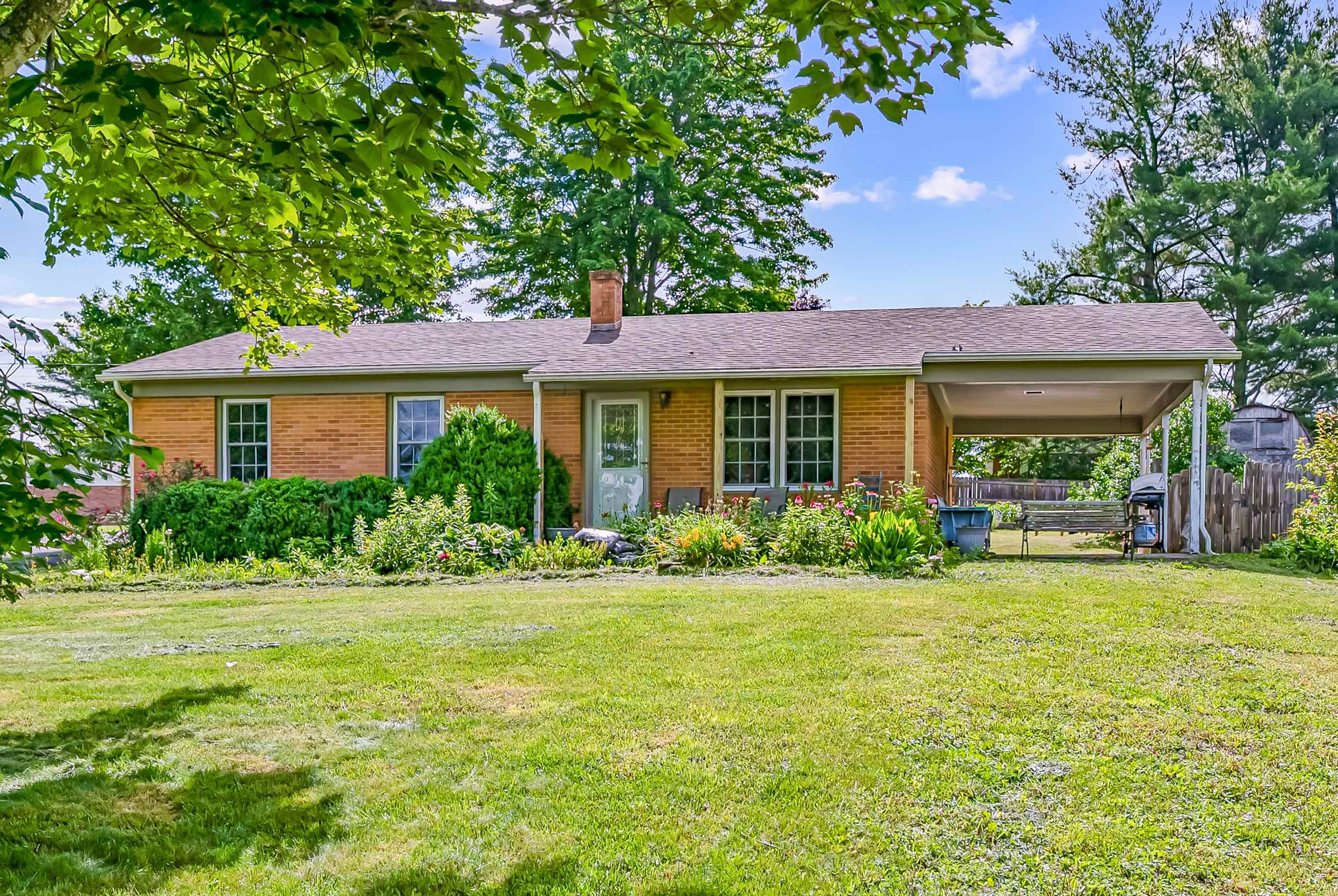 Charming 3 bed, 1 bath brick home on a 0.50-acre lot in beautiful Hillsville, VA! With 975 sq ft on the main level and a partially finished basement, this home is perfect for first-time buyers, downsizers, or investors. The spacious backyard is fully fenced for privacy and features beautifully landscaped raised garden beds—ideal for relaxing or entertaining.  Located just under 2 miles to I-77, you're only 20 minutes to Wytheville, 35 minutes to Mount Airy, and about an hour to Winston-Salem or Blacksburg (home of Virginia Tech). Less than 2 hours to both Greensboro and Charlotte, NC!  This well-kept home offers solid brick construction, plenty of natural light, and great potential to expand living space in the basement. A wonderful mix of small-town charm and commuter convenience—don't miss your chance to make it yours!