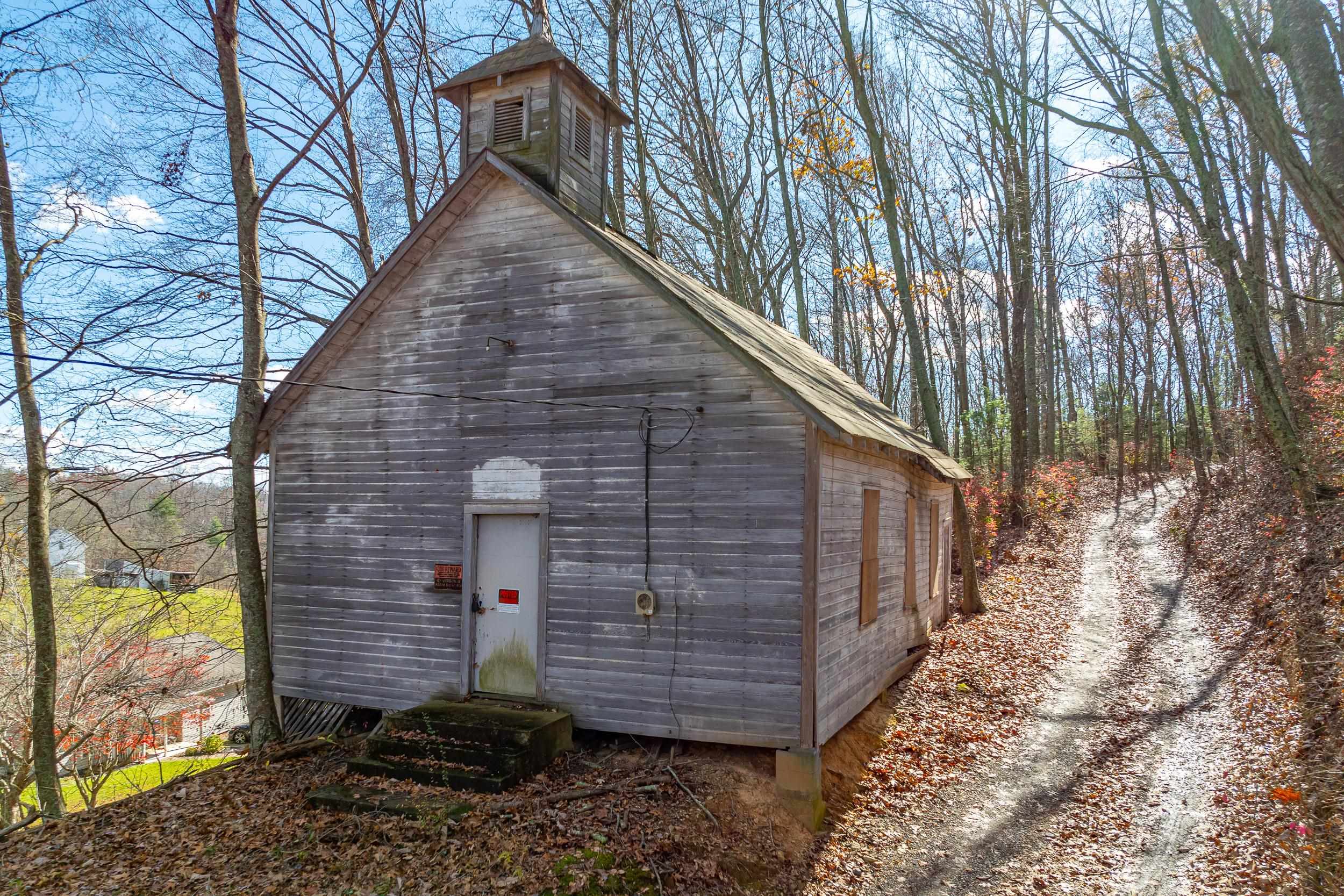 Nestled in the Blue Ridge Mountains of Virginia, the historic Webb Presbyterian church built c.1900 offers a unique opportunity to own a piece of local Appalachia history. Situated on a .3 acre, the property exudes tranquility as it’s hidden in the peaceful yet conveniently located countryside, only half a mile to HWY 58. This church is in need of modernization but does have electricity, making it a perfect project for preservation enthusiasts, artists, or visionaries seeking a one-of-a-kind retreat. Featuring authentic original architecture, including locust wood-frame structure, amber stained glass windows, and pitched roof clad with pressed tin shingles, the building has charm and lots of potential. Located in close proximity to the areas of Hillsville, Meadows of Dan, and Fancy Gap. Activities, sights, and events such as Galax's annual Old Fiddlers Convention are plentiful in this mountain community. Call today for the opportunity to own a property from a simpler time!