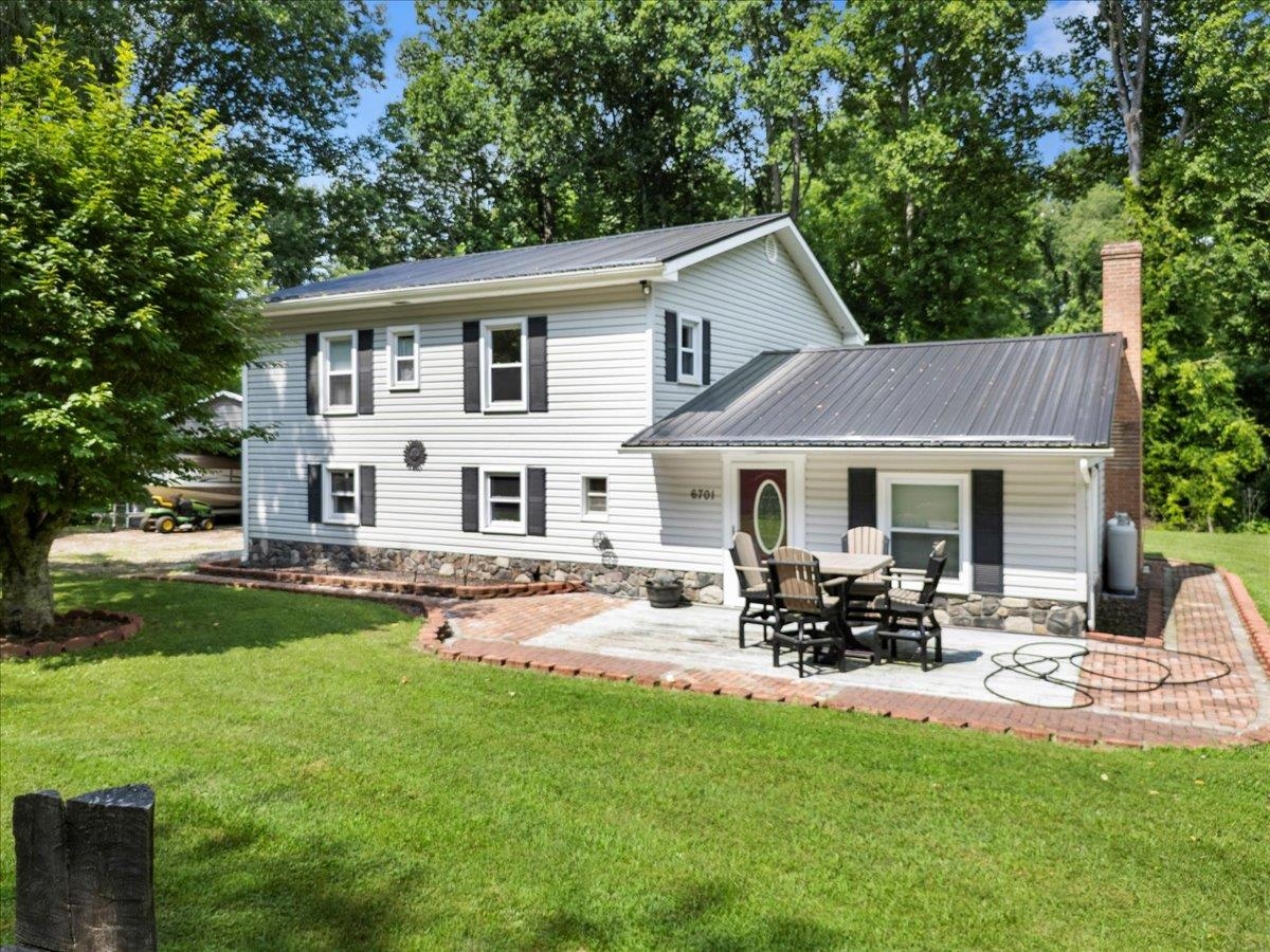 The best of lakeside living in this professionally remodeled home in the desirable Lakeview subdivision of Claytor Lake. Deeded dock access with parking & a short walk or golf cart ride to DeHaven Park, the perfect setting for waterfront fun & relaxation! Thoughtfully updated residence features NEW floors, dual-zoned heat pump systems, metal roof, stone underpinning, gas logs, SS appliances, washer/dryer, doors, soffit venting, toilets & 3-bay metal building!! Septic pumped March 2025! Bright and airy layout thanks to generous windows. Living rm with beautiful slate fireplace. Eat-in kitchen impresses with granite counters, tile backsplash & soft-close cabinetry all designed to delight culinary enthusiasts. Vaulted family room. 3 generously sized bedrooms, all with LVP flooring, including a spacious primary suite boasting two closets, dual sinks & tiled walk-in shower. Level, private 2+ acre lot! Radford University is an easy 30-min drive! Everything you need is here – let's go look!