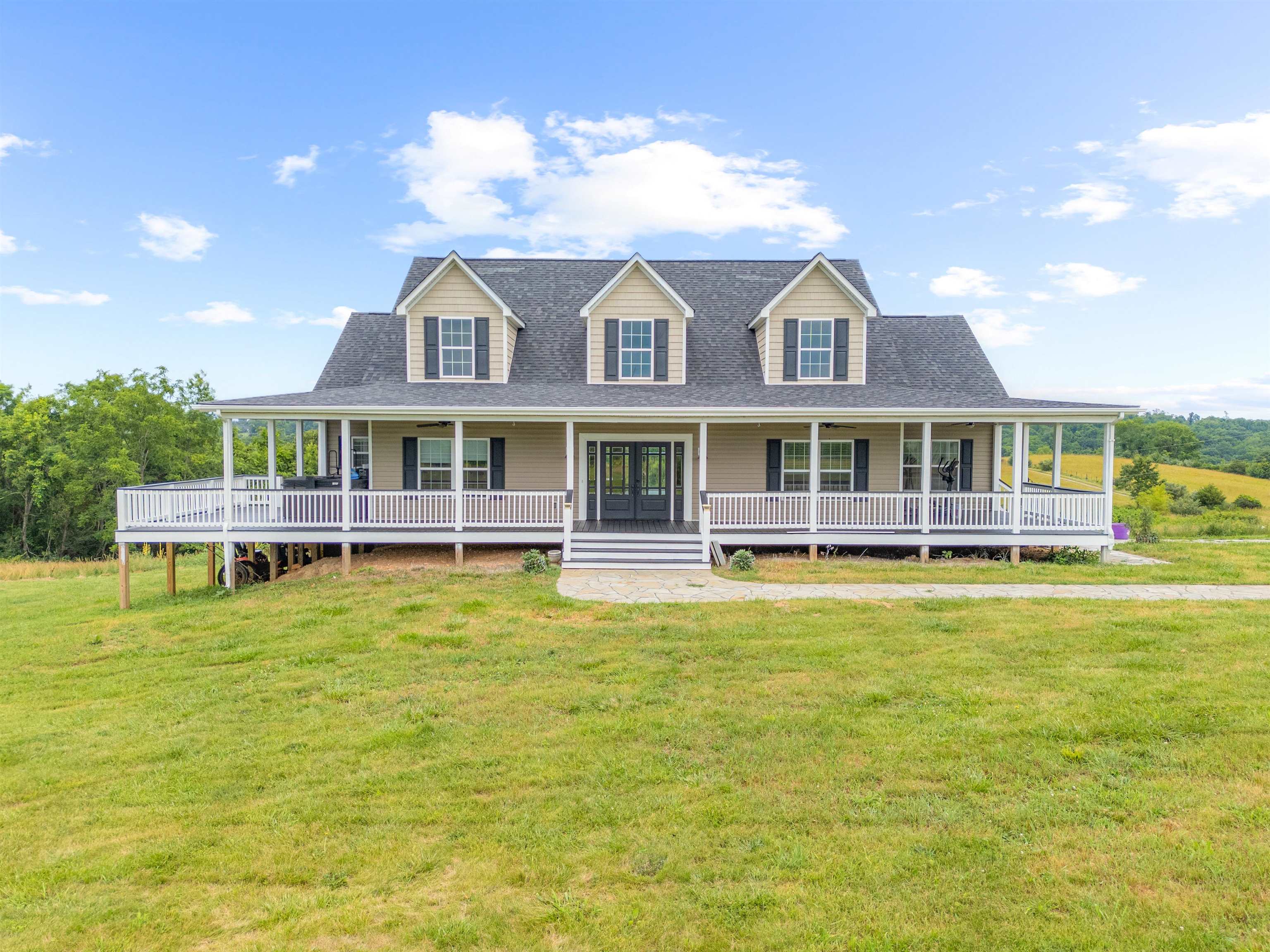 Gorgeous 2018-built home situated on 65 pristine acres with underground utilities and endless potential! This stunning property features 3 oversized bedrooms and 3 spacious bathrooms—all on the main level—plus over 3,000 sq ft of unfinished space ready for your vision. Enjoy 9-ft ceilings on all 3 levels, a full walk-out basement, and an open-concept layout with a grand foyer and generous laundry room. The master bedroom and dining room both open to private balconies, perfect for enjoying the serene views. Step onto the covered porch, soak in the hot tub, and take in the beauty of the flat, cleared land. Bonus: a second home on the property offers great rental or guest space potential. Whether you're an investor, homeowner, or seeking a property for farming or multi-use development, this land offers exceptional opportunity. A rare find with privacy, flexibility, and room to grow.