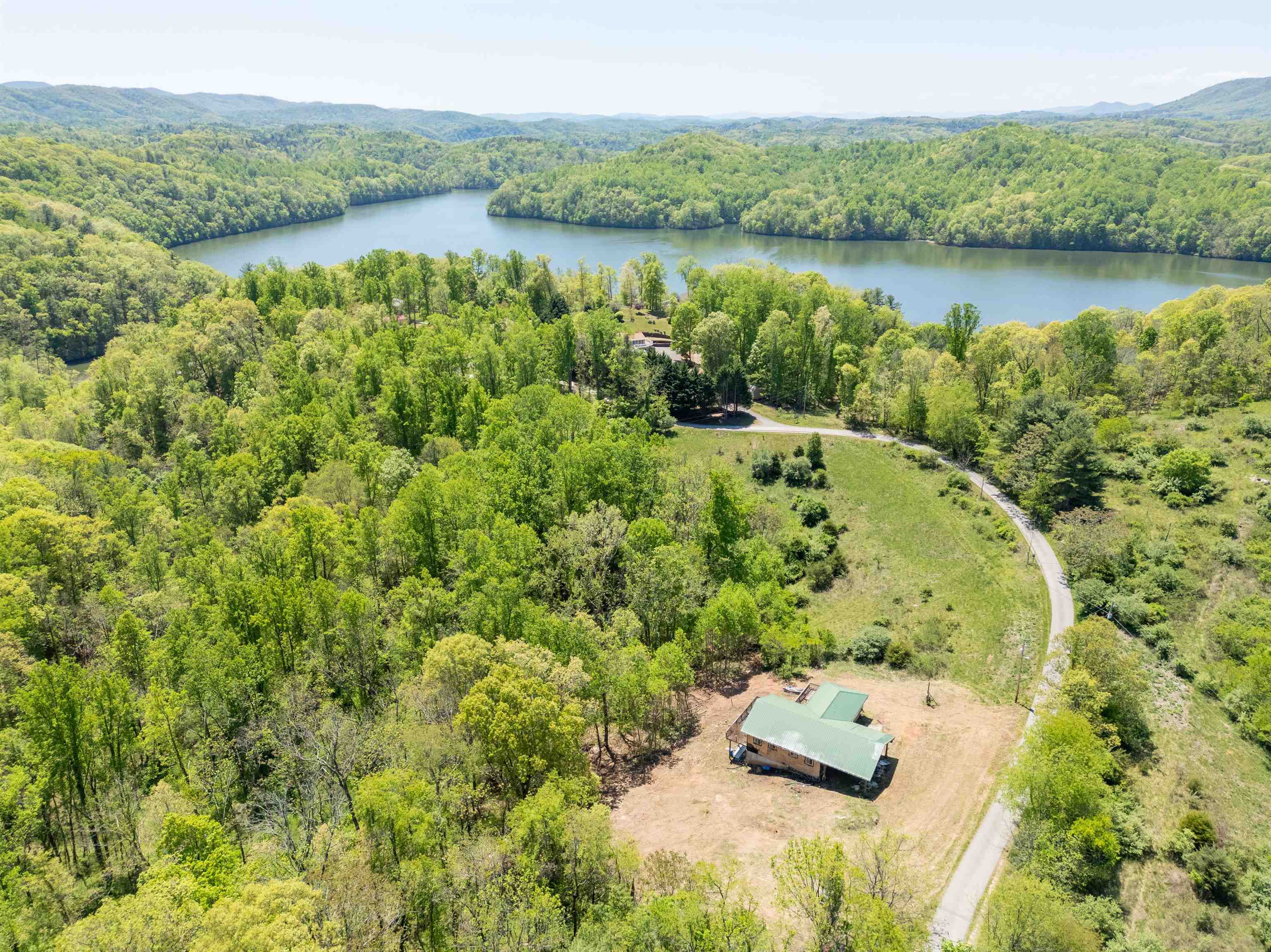 Are you searching for a weekend get-a-way on Claytor Lake? Look no further! This +/- 1.1613 acre tract features a partially constructed custom energy-efficient straw bale home. The home is under roof and approximately 90% of the interior framing is complete. The kitchen has custom cabinets with concrete counters and an island. The home is framed to be a 3 bedroom, 3 bath home once complete. The basement is framed to have a storage area or the 3rd bedroom, the 3rd bath, laundry and an area to be a finished den (or unfinished basement). There is also a sliding door which leads to the rear yard. The front entrance is covered and would make a nice patio space. The lots adjoin, so you can purchase one or multiple lots to get your desired acreage! Enjoy lake access through the +/- 0.66 acre Common Area which serves all offerings. The common area has nice frontage on a Claytor Lake cove just a few hundred yards from the main lake channel.