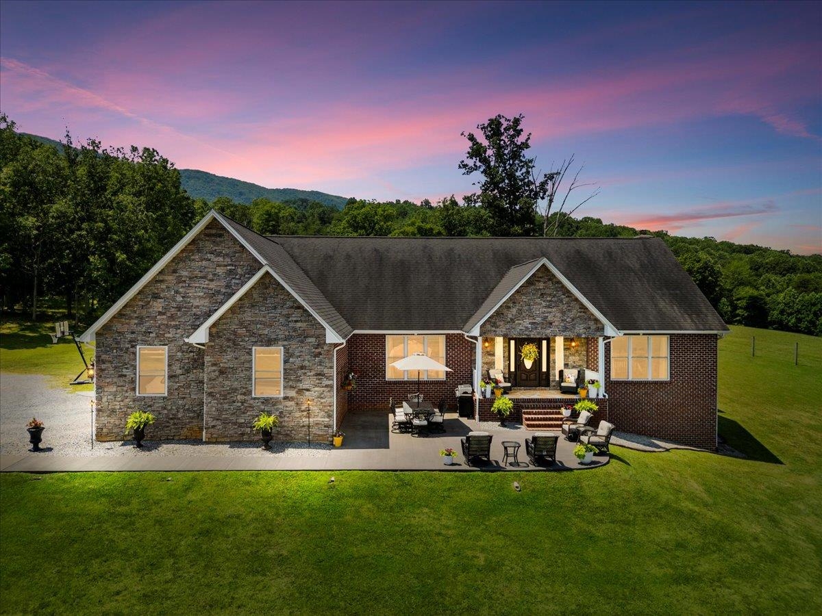 Spectacular views, privacy & exceptional quality abound @ this gentleman's farm located only minutes from VT. This custom built single owner brick & stone home w/primary living on the main level has a full beautifully finished walk-out lower level. The vaulted living room w/stone FP opens to the well appointed spacious kitchen & breakfast room. A gracious large primary suite w/a spa bath & walk-in closet is privately located from the other main level bedrooms. Hardwood & tile floors throughout the main level, granite tops, stainless appliances, tile baths are just a few of the amenities to enjoy. The lower level has a guest suite, office, wet bar, wood stove, gym, family room & extra storage. Outside relax on the huge patio & two porches, overlooking gorgeous mountain views & wet weather pond. Including a Generac generator, workshop, detached tractor garage, sheds, fully fenced pastures,a tractor, truck, trailers & equipment-all in exceptional condition to run your very own farm.