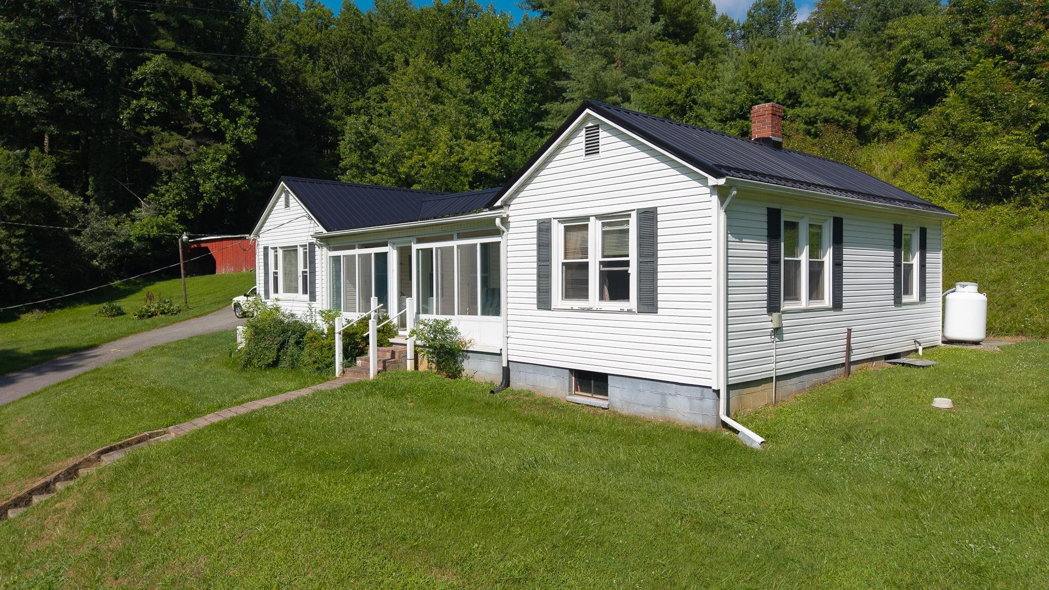 Check out this investment home! This 2 bed, 1 bath home in the Riner area offers 1 level living & a room that could serve as a 3rd non-conforming bed. Built in 1953, it home has undergone several improvements. The metal roof in 2019, whole house generator in 2020/2021 & carpet in 2016. Home has double-paned, tilt in windows. There are multiple heat sources - outdoor wood furnace, multiple propane heaters and baseboard heat. Partial unfinished basement is ideal for storage. Home could use updates & moderation but has good bones. Take in the scenery from the screened in porch & sunroom. There are 2 barns, a detached garage & a shed. Enjoy the grapevine & several garden areas. Home sits on 2.5 acres within a short commute of Riner, Christiansburg, and Floyd. A new survey was just completed.