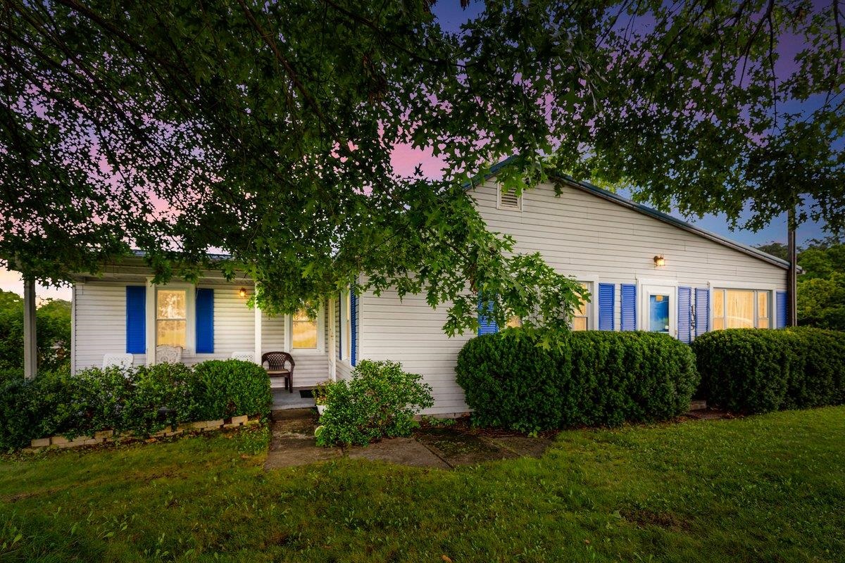Peaceful Ranch with Mountain Views on just under 2 Acres! - Enjoy country living w/ stunning views over open fields from this potential homestead on a corner lot. Surrounded by mature spruce/oak/fruit trees, this well kept home invites you to relax on the front porch in the mornings/evenings. Inside features a cozy gas log fireplace, an eat-in kitchen w/ large pantry, generous closet space in both bedrooms/bathrooms. A combination of hardwood, parquet, & laminate flooring. Outside features include four outbuildings - one a custom built 10x16 red barn shed w/ loft, a large enclosed garden area, an enclosure for small livestock, a covered picnic grilling pad, & a detached one-car garage w/a separate driveway off Market St w/ ample parking for family gatherings. Three of the outbuildings and the home have updated electric & rewired in 2019. New metal roof in 2019.  The basement provides plenty of storage space. This perfect mix of comfort, charm, & country living is ready to welcome you!