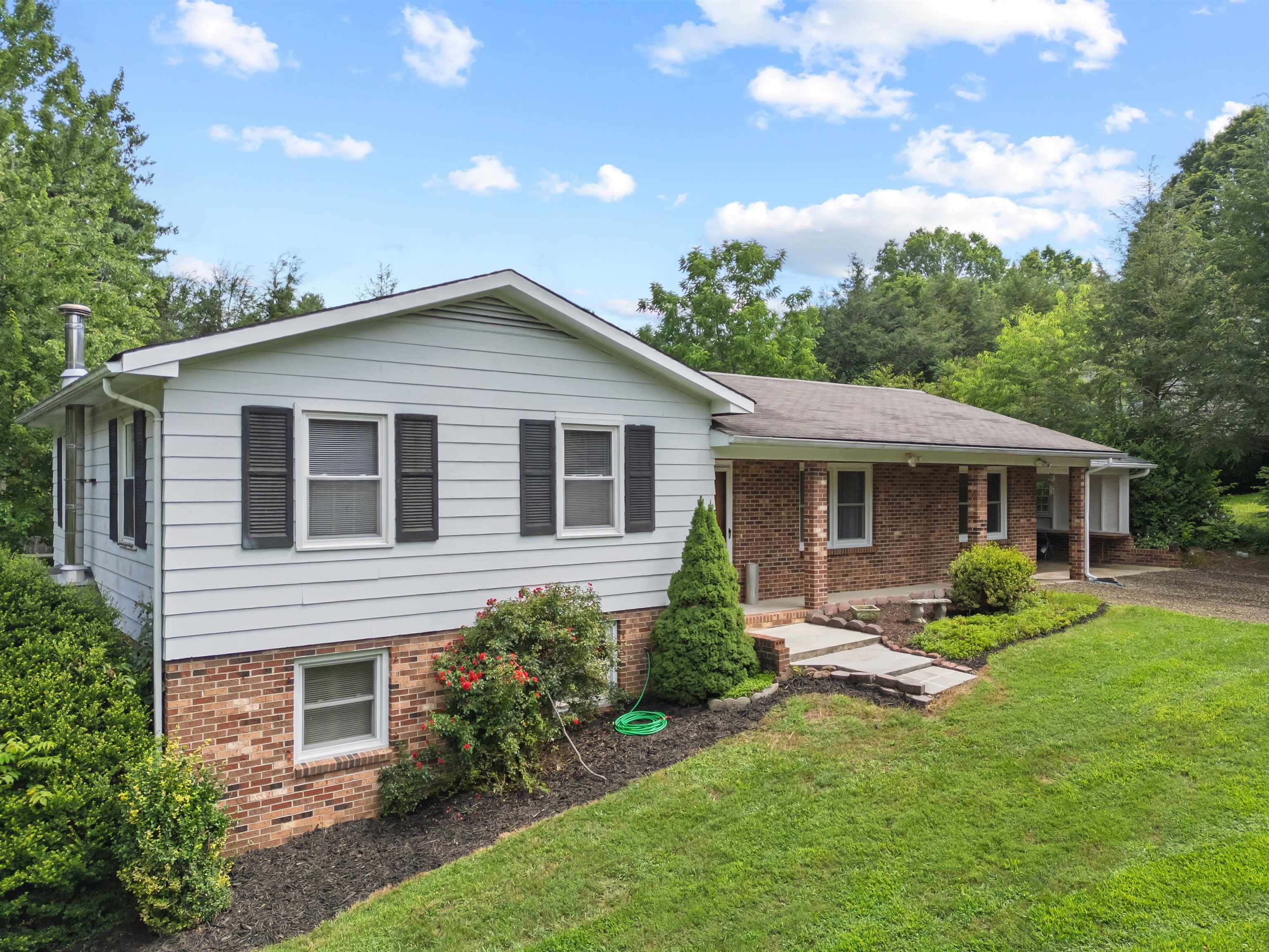 Welcome to this spacious 4-bedroom, 3-bath split foyer ranch home located just outside of Independence, VA. Perfectly suited for a growing family, this home offers a generous layout with a large kitchen ideal for cooking and gathering, a comfortable living room, and a cozy den for relaxing or entertaining. Enjoy the convenience of an attached carport and the comfort of three full bathrooms, plenty of space for everyone. Featuring central A/C and multiple heating sources to keep your family comfortable. Sitting on nearly an acre of land, the property provides room to play, garden, or simply enjoy the peaceful surroundings. Located just minutes from town, schools, and local amenities, you’ll also love the close proximity to the New River, offering easy access to fishing, kayaking, and outdoor adventure. Having been steadily updated and maintained, this home combines comfort, space, and location. Don’t miss this opportunity to make it your own!