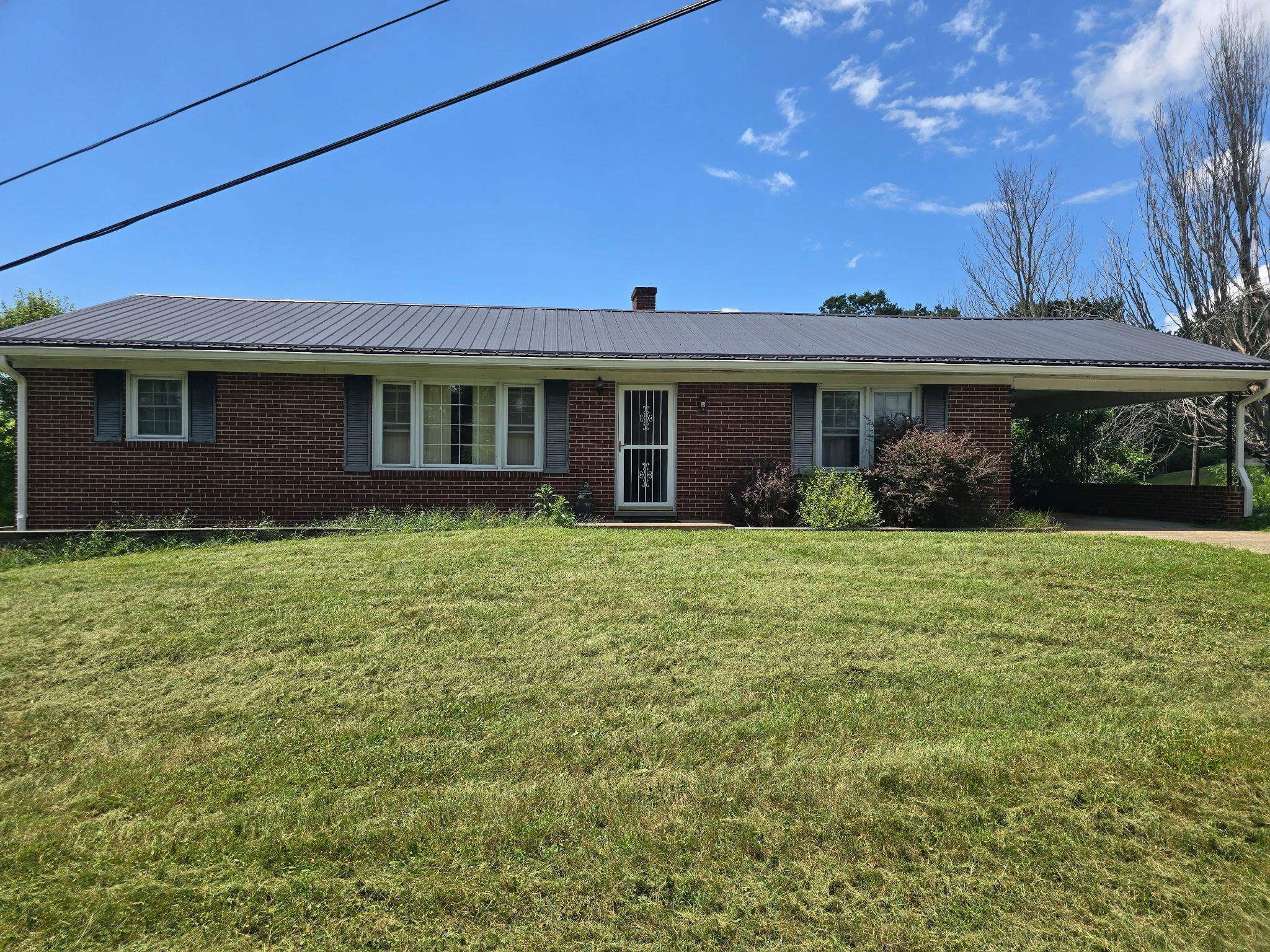 This 3 bedroom, 1-bath brick ranch offers a great opportunity with plenty of updates already completed. Featuring a full unfinished basement, this home includes hardwood floors in some rooms, a metal roof, carport, and both an electric heat pump and propane heat for year-round comfort. Most appliances have been replaced within the past year, and recent improvements include new front gutters, replacement windows, updated plumbing, and most electrical systems. Serviced by well and septic, this home does need some repairs, making it ideal for buyers looking to add their personal touch. Seller will review all offers. Enjoy the peaceful setting and beautiful views from this solid home with great potential!  Plenty of apple trees, grape vines and views await you.