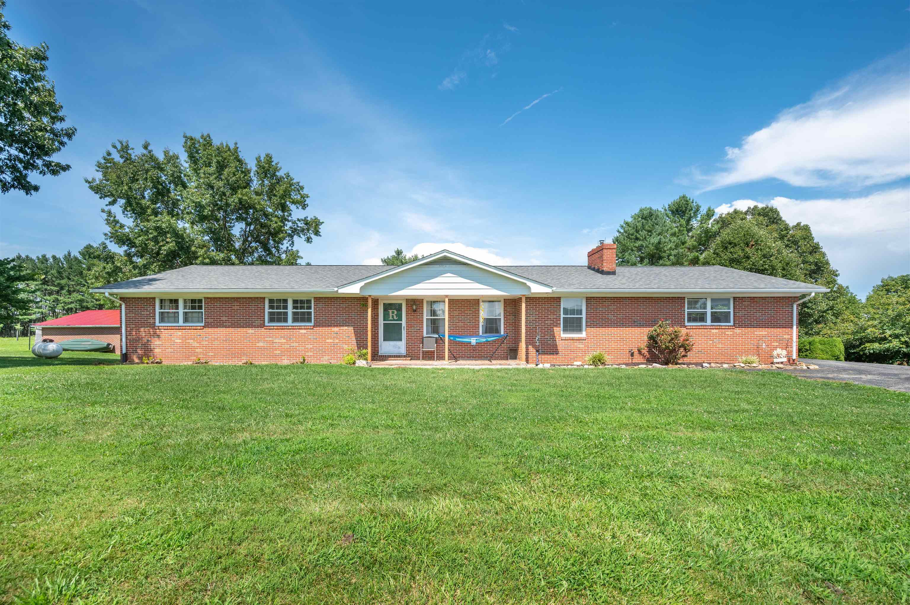 Lovely Brick Ranch with Room to Grow! This spacious 5 bedroom, 3-bathroom brick ranch offers comfortable living convenient to the Town of Floyd, Christiansburg, Blacksburg and Radford.Experience the inviting charm of an open-concept kitchen with a central island, seamlessly flowing into the spacious living room. Conveniently located on the main floor are the generously sized laundry and potential mudroom. Beautiful hardwoods run through the home, while the master bedroom offers a private retreat with its own en suite bathroom. The full basement provides an additional living space—ideal for a rec room, home office, kids play area or guest suite that includes a kitchenette. Outside, you’ll find an airy sunroom, large yard for kids and pets, a 2-car garage, a 1-car carport—plenty of room for parking and storage. This home combines functionality, space, and a great location—all in one! Call today to schedule a showing!