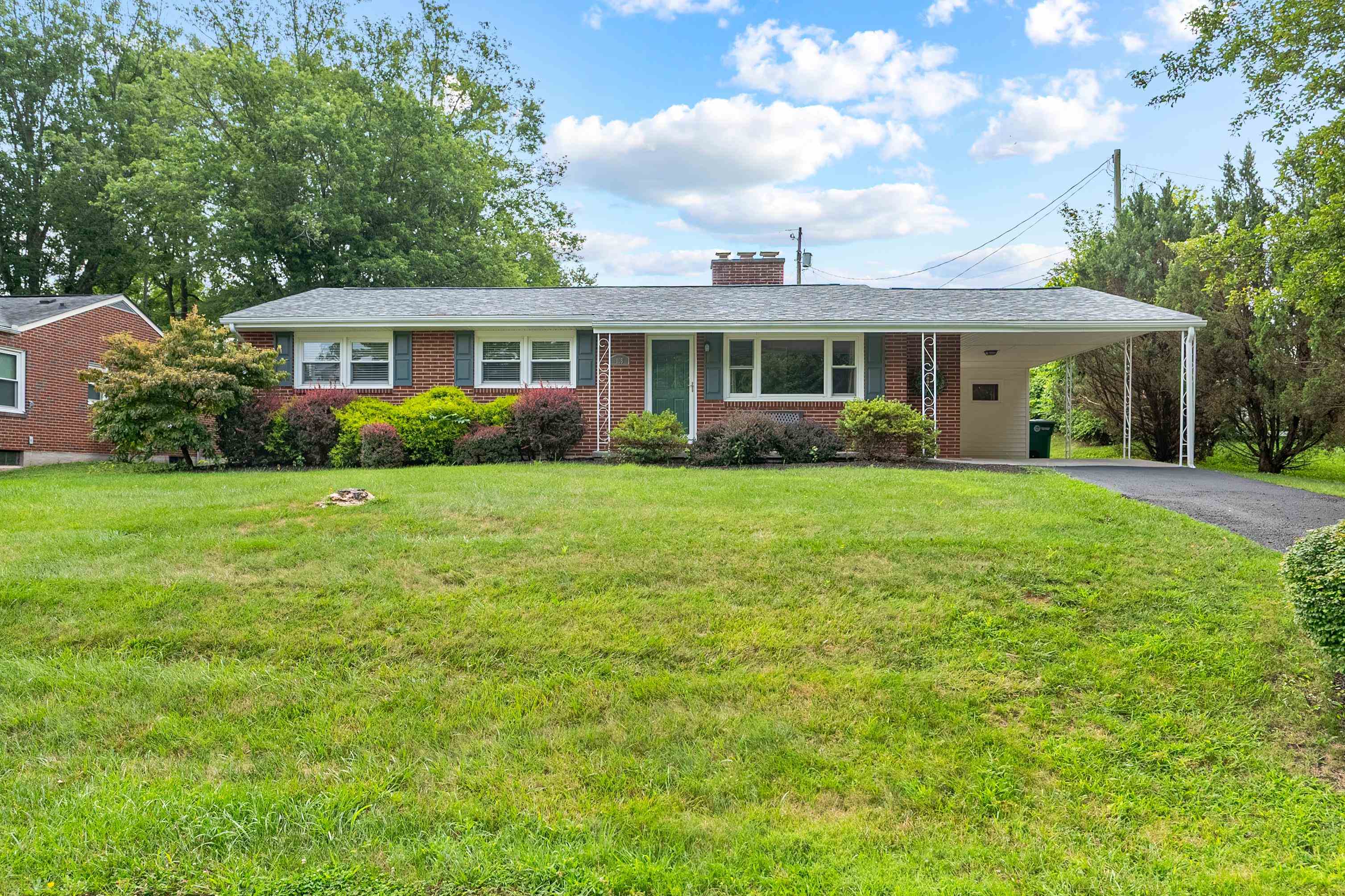 This well maintained 3-bedroom, 1-bath brick ranch blends classic charm with thoughtful updates. The bathroom has been modified for handicap accessibility, offering added comfort and convenience. Inside, you'll find hardwood floors, a cozy fireplace, and a full spacious basement perfect for storage or additional living space. A covered carport provides easy parking and beautifully landscaped yard.