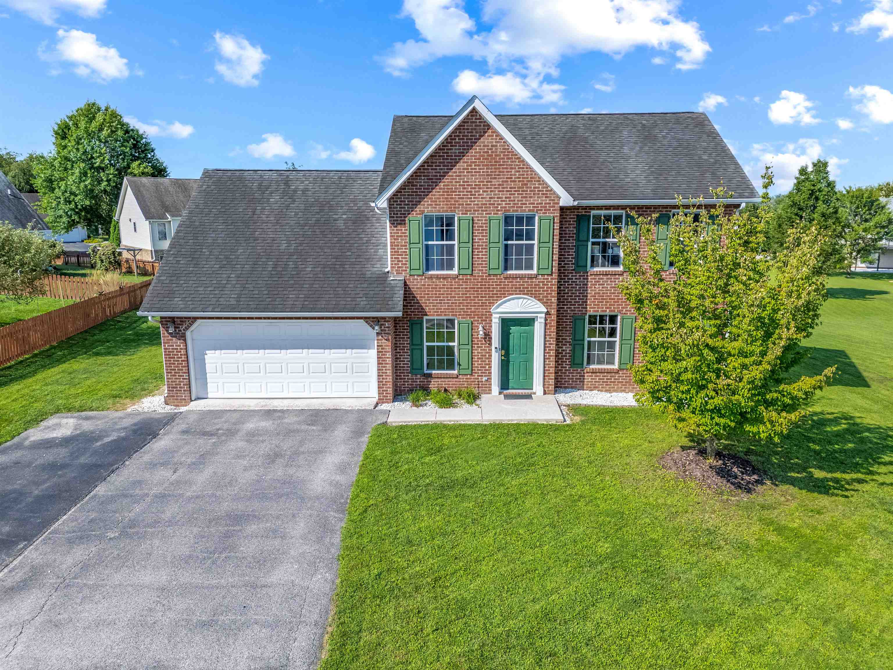 Spacious Colonial in the popular and conveniently located Windsor Estates neighborhood! Situated on a level, landscaped lot, this 4-bedroom, 2.5-bath home offers 2,010 square feet of inviting living space. The main level features a bright and spacious living room, a well-equipped kitchen, and a versatile dining room currently used as a home office. Upstairs, you'll find four generously sized bedrooms, including a serene primary suite with private bath and large walk-in closet, plus a full hall bath. Recent updates include a new outdoor HVAC unit (May 2025), a sleek Trex deck ideal for entertaining, newer carpet in the living room, and updated refrigerator and dishwasher. A 2-car garage, pull-down attic with stairs, and new shed provide excellent storage. Enjoy walkable neighborhood access to the new Huckleberry Park and a prime location just minutes from Virginia Tech, Radford University, shopping, and dining. Comfort, convenience, and charm all in one! OPEN HOUSE SATURDAY 8/9 FROM 1-3