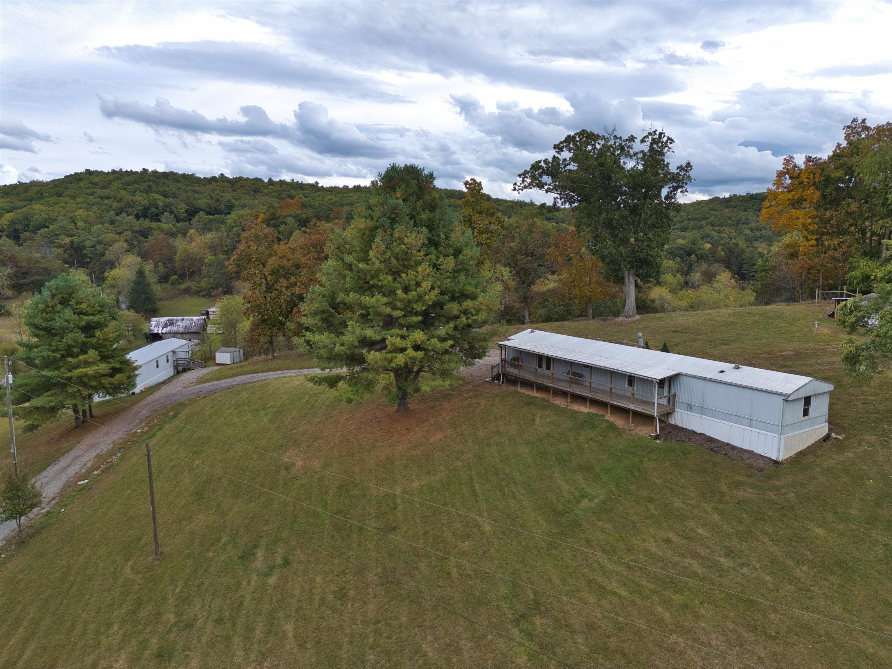 Wonderful investment opportunity with two singlewide mobile homes on five acres minutes from the heart of Riner and located in the Auburn High School District. There is a 1997 16'x76', three bedroom, two bath singlewide and  a 1999 14'x60' two bedroom, two bath singlewide. The three bedroom home has Central A/C, china cabinet conveys, primary bedroom has a built-in bed, walk-in closet and french door that leads to covered deck. Wood pellet stove in living room. Two bedroom home has covered rear deck entrance, Central A/C, laundry room, island in kitchen and metal shed out back.  All is located on 5 acres of land with a small creek with room to build another home, have cattle, horses, etc..  Call today for a private showing!