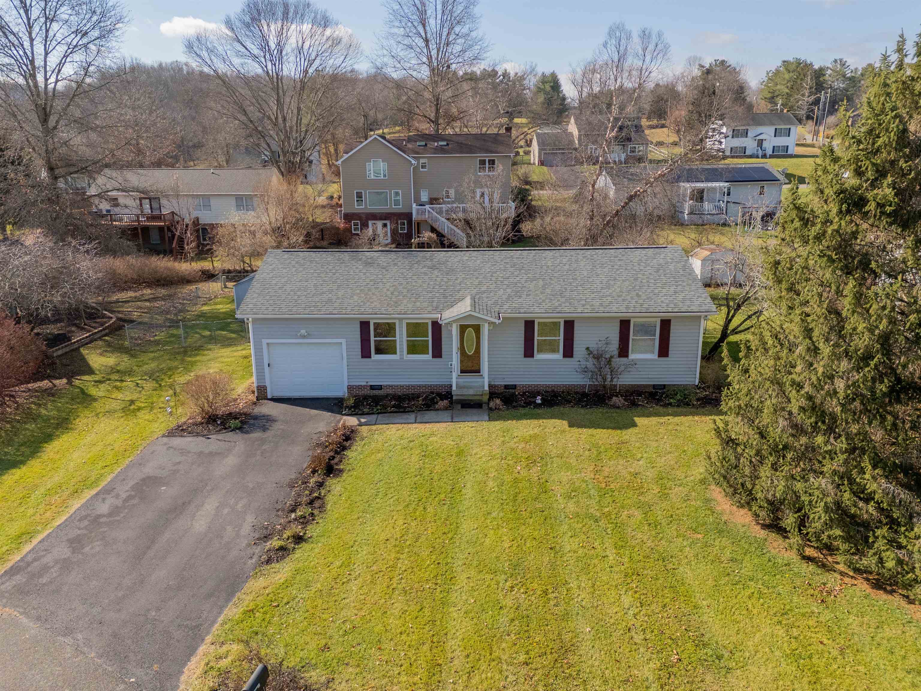 Welcome to 1309 Sandy Circle, a well maintained and updated home that has so many things to love! Situated on a cul-de-sac, the property has a flat, fenced, backyard that comes with a shed for extra storage. You're just steps away from H.L. Price Park with trails and green space to enjoy, close to dining & entertainment, and just minutes from Downtown Blacksburg and Virginia Tech. Inside you'll find updates like attractive LVP flooring, new carpet in the bedrooms, remodeled bathrooms, and fresh paint throughout. You can enter through the living room that features large windows that give the space great natural light, or through the mud room/laundry room off of the attached garage. The primary bedroom features a well-sized ensuite bathroom with a walk-in shower. Off of the dining room, you'll enjoy a deck that overlooks the backyard with sunset views. Other notable features: a newly installed range, thoughtful landscaping, an encapsulated crawl space, and a roof replaced in 2017.