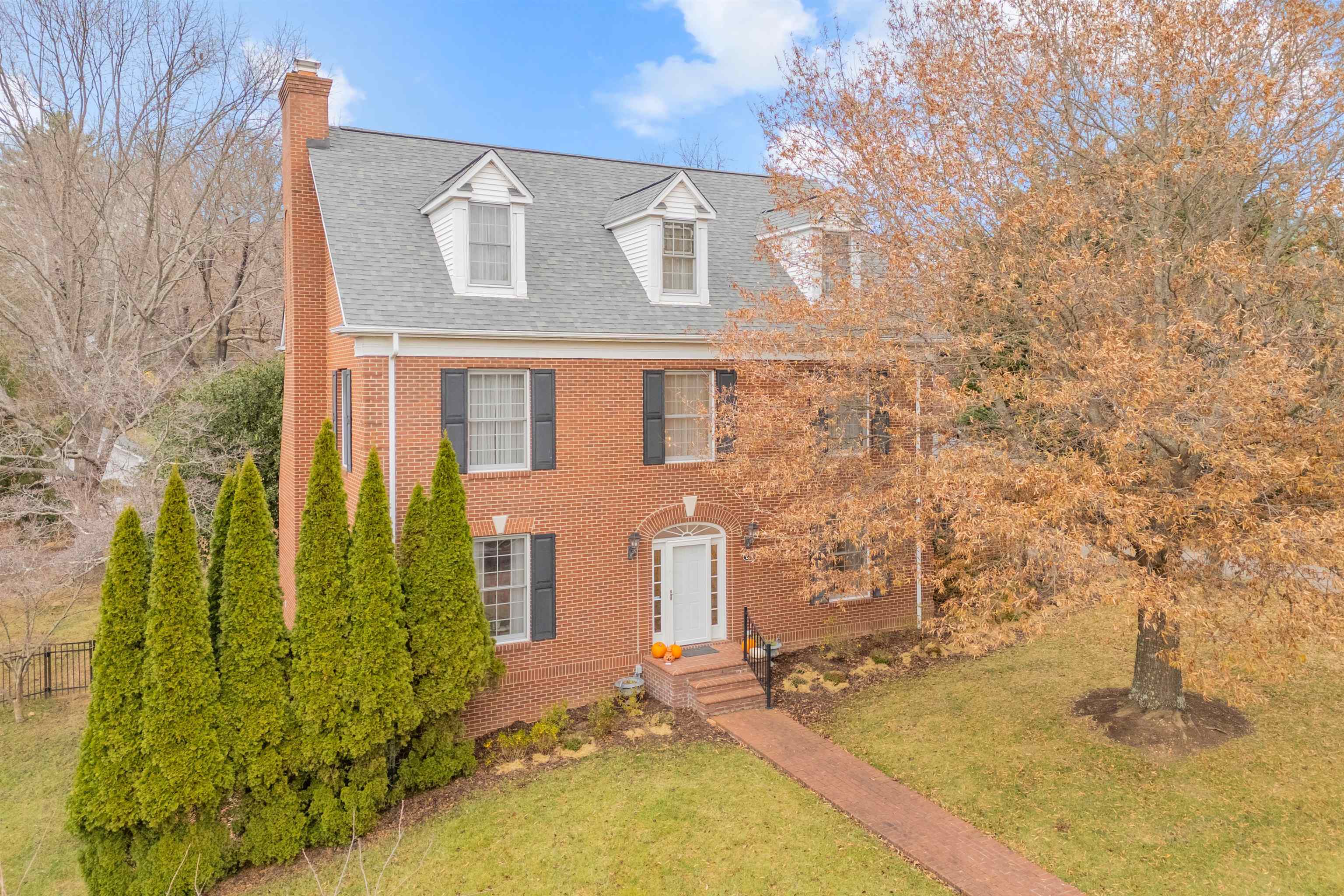 Welcome to this distinguished 6-bedroom, 4.5-bath Colonial nestled in one of Blacksburg’s most sought-after neighborhoods. Situated on a rare double lot (~0.8 acres), this stately brick home features a fully fenced, beautifully landscaped yard. Inside, enjoy elegant and inviting living spaces with hardwood floors throughout. The upgraded gourmet kitchen boasts high-end appliances, custom cabinetry, granite countertops, and a large island. The formal living and family rooms each have a fireplace, and the large  sunroom opens to the backyard. Upstairs offers a luxurious primary suite with WIC and heated tile floors in the spa-like bath, two additional bedrooms, and a full bath. The third level features two more bedrooms, full bath and laundry. The walk-out basement includes a gas fireplace, kitchenette, rec room, office space, 6th bedroom and full bath. Recent updates: new kitchen, roof, water heater, hardwood flooring, & fresh paint. Minutes from downtown, groceries & restaurants.